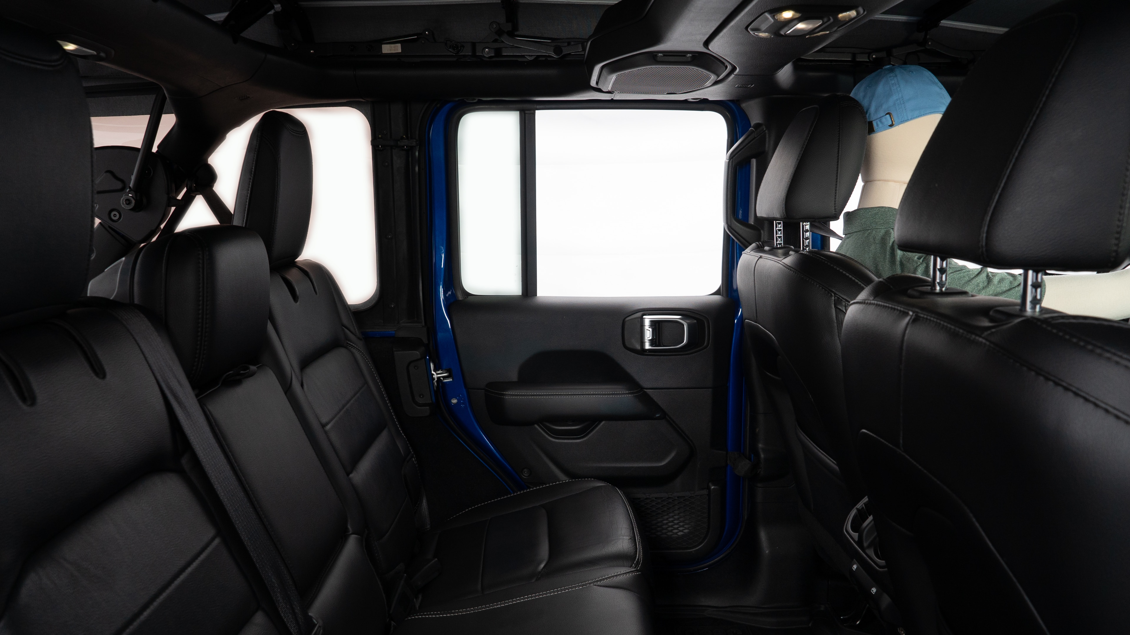 A series of second-row backseat photos is shown including one seating a baby seat and one seating a 6'1" mannequin.