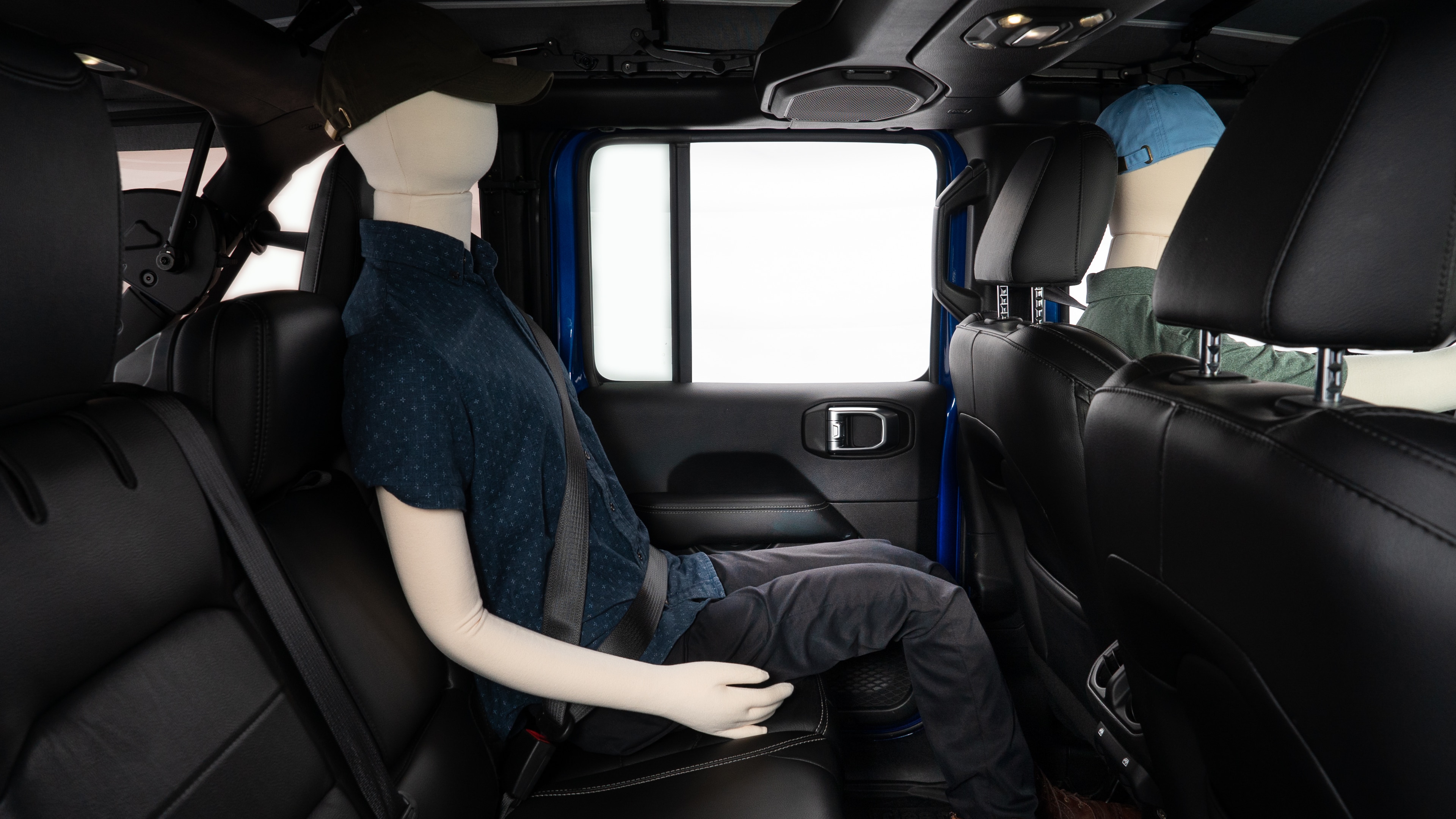 A series of second-row backseat photos is shown including one seating a baby seat and one seating a 6'1" mannequin.