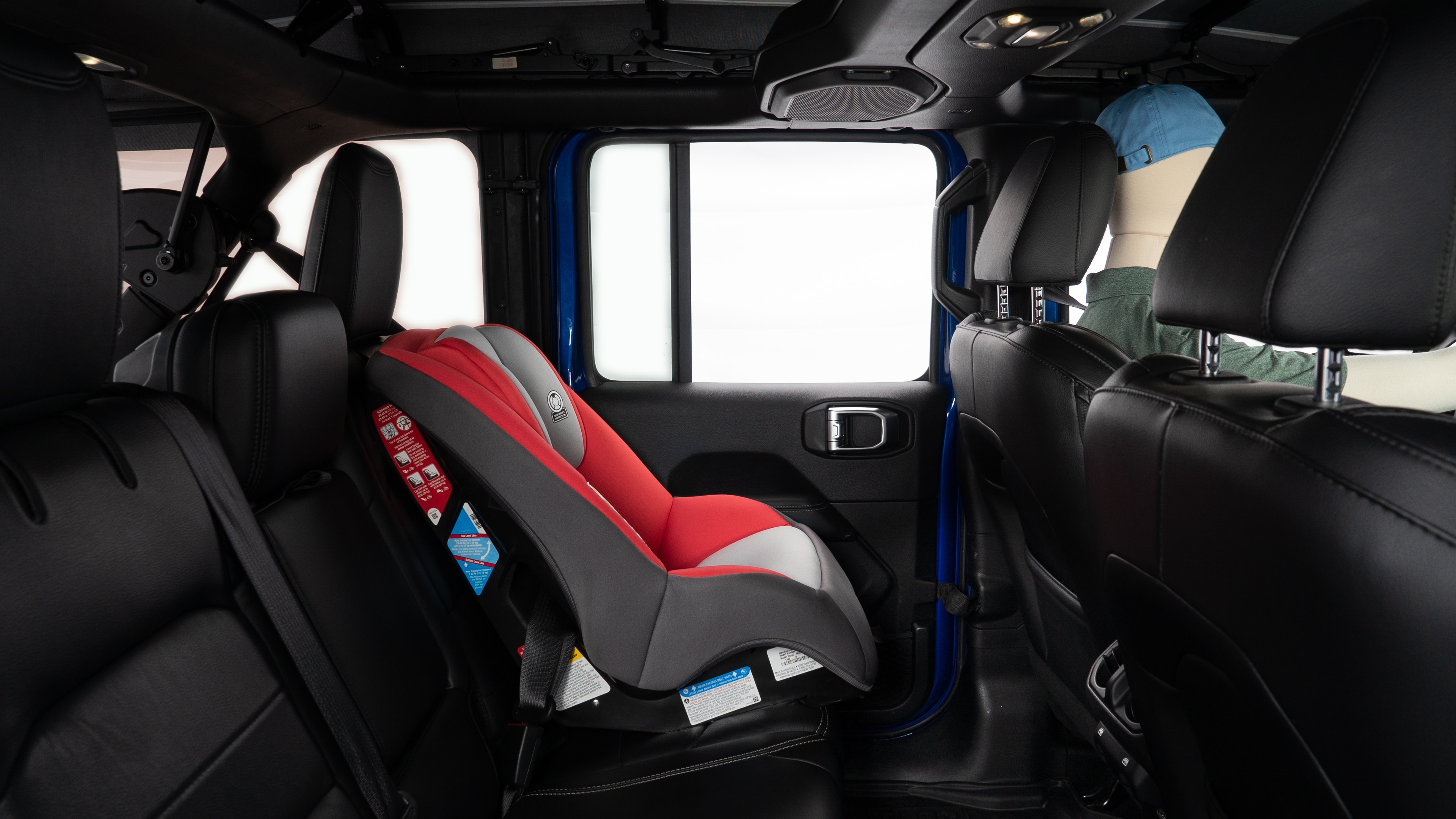 A series of second-row backseat photos is shown including one seating a baby seat and one seating a 6'1" mannequin.
