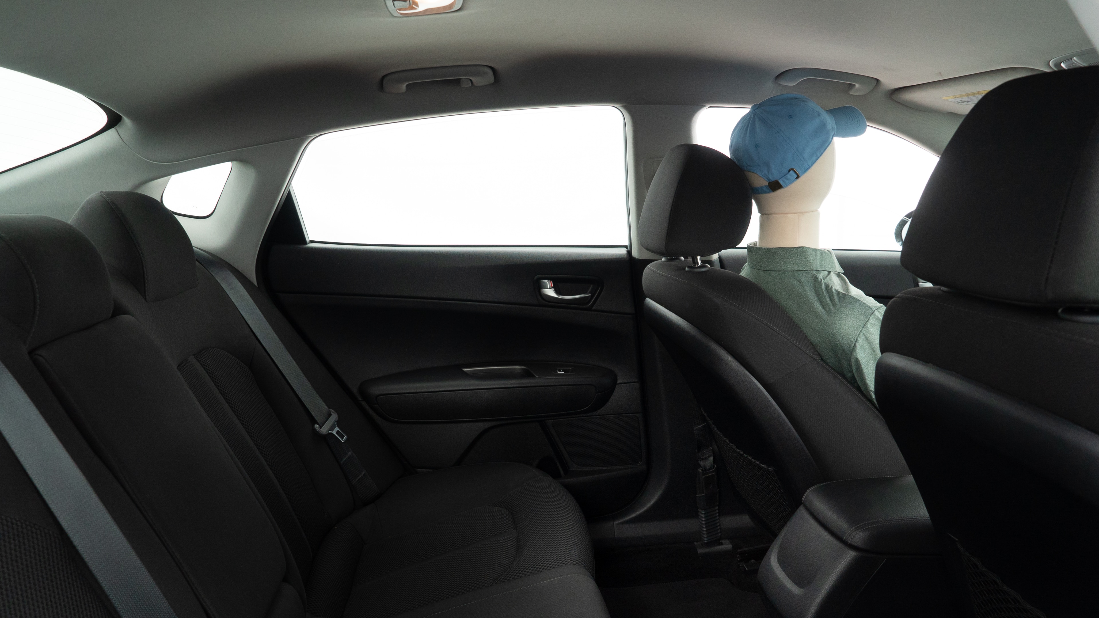 A series of second-row backseat photos is shown including one seating a baby seat and one seating a 6'1" mannequin.