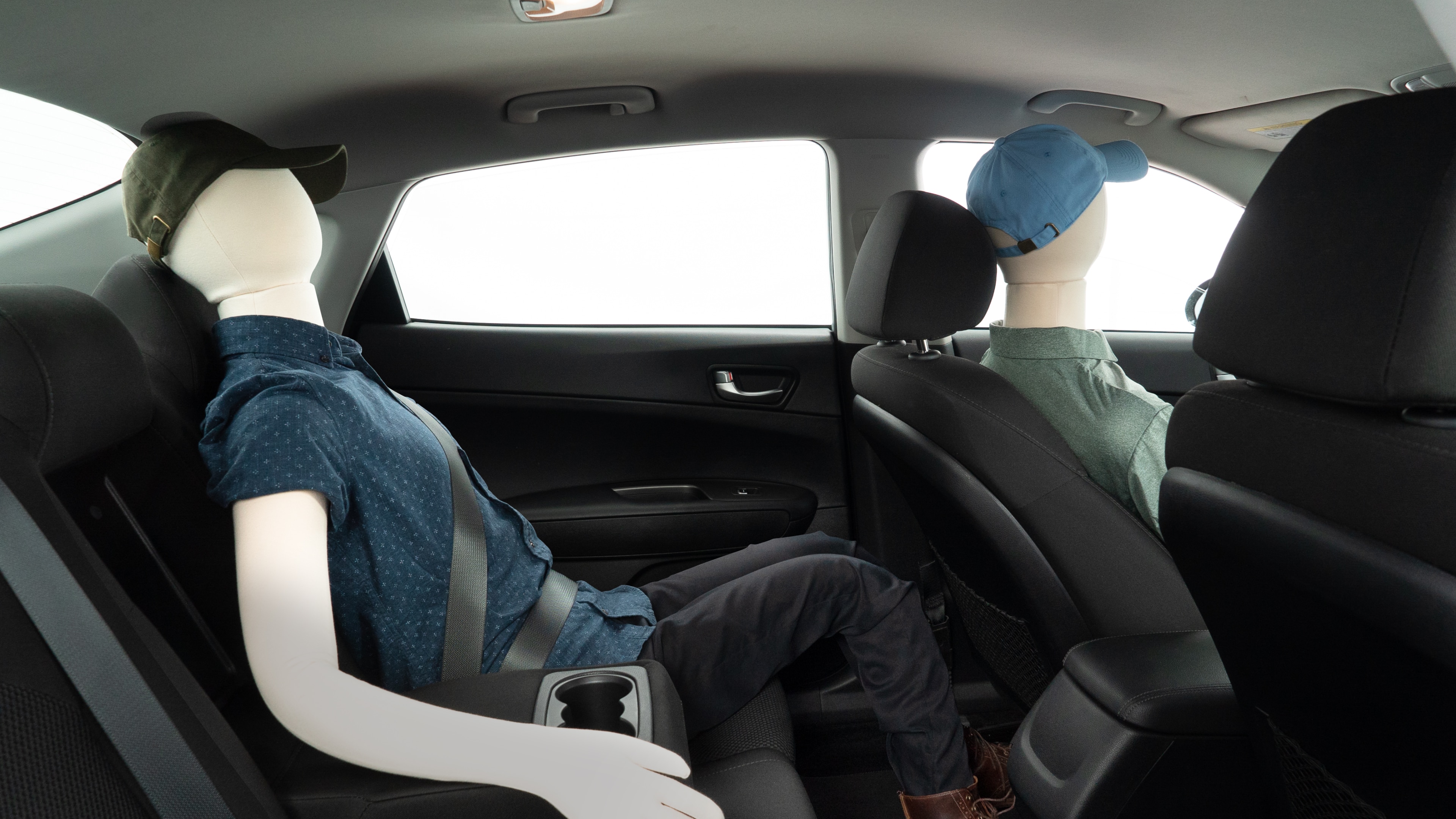 A series of second-row backseat photos is shown including one seating a baby seat and one seating a 6'1" mannequin.