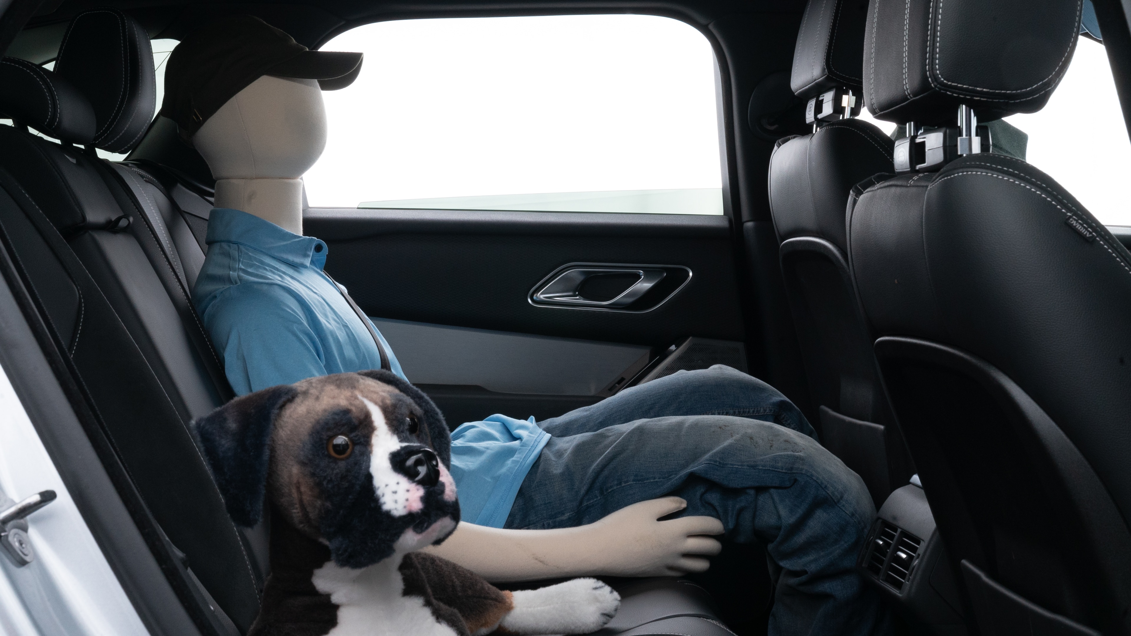 A series of second-row backseat photos is shown including one seating a baby seat and one seating a 6'1" mannequin.