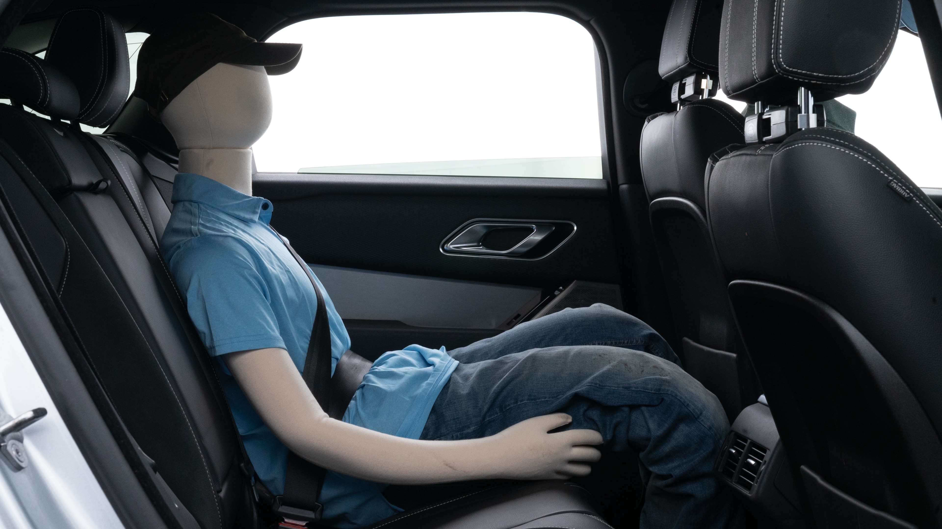 A series of second-row backseat photos is shown including one seating a baby seat and one seating a 6'1" mannequin.