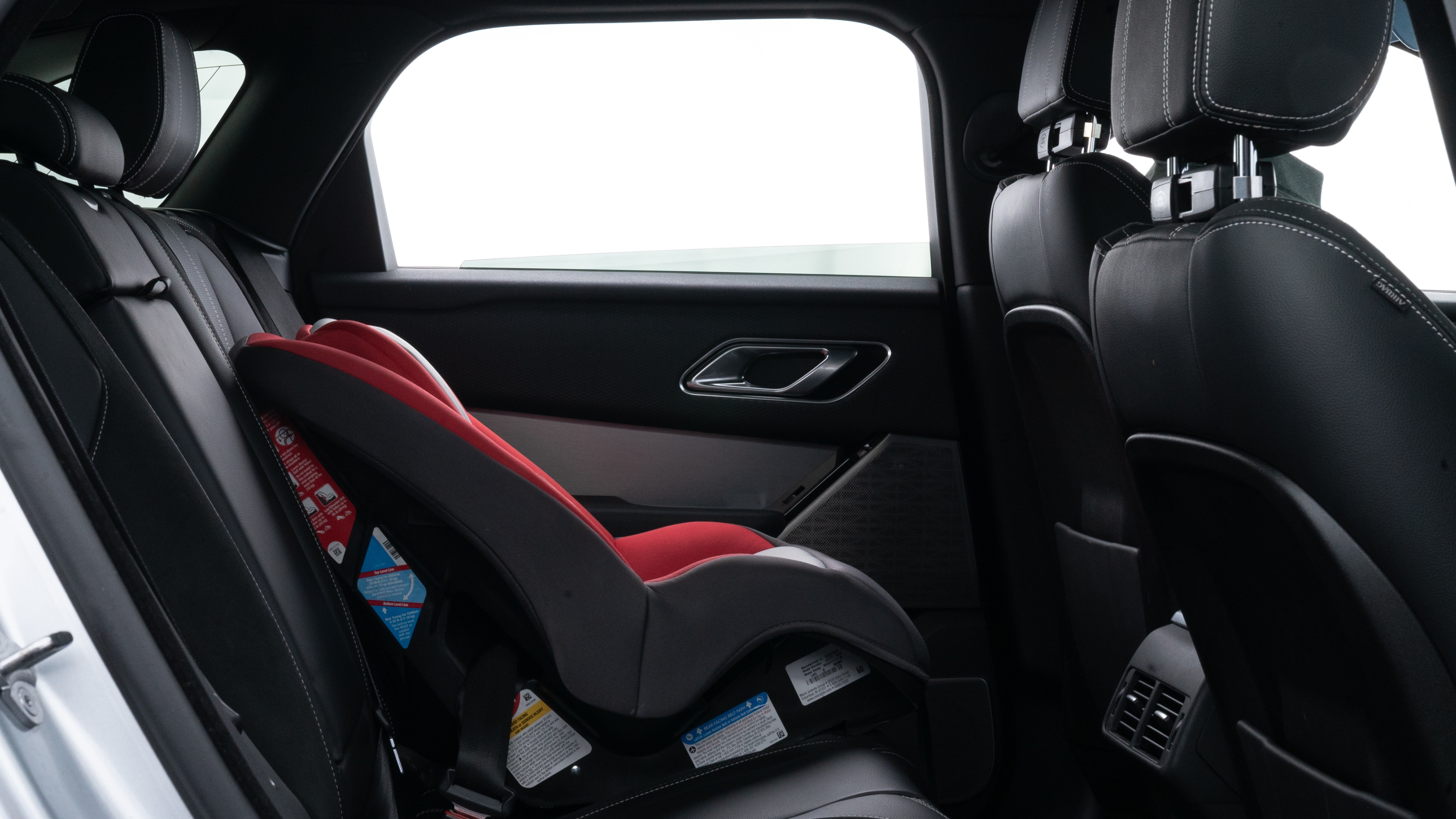 A series of second-row backseat photos is shown including one seating a baby seat and one seating a 6'1" mannequin.