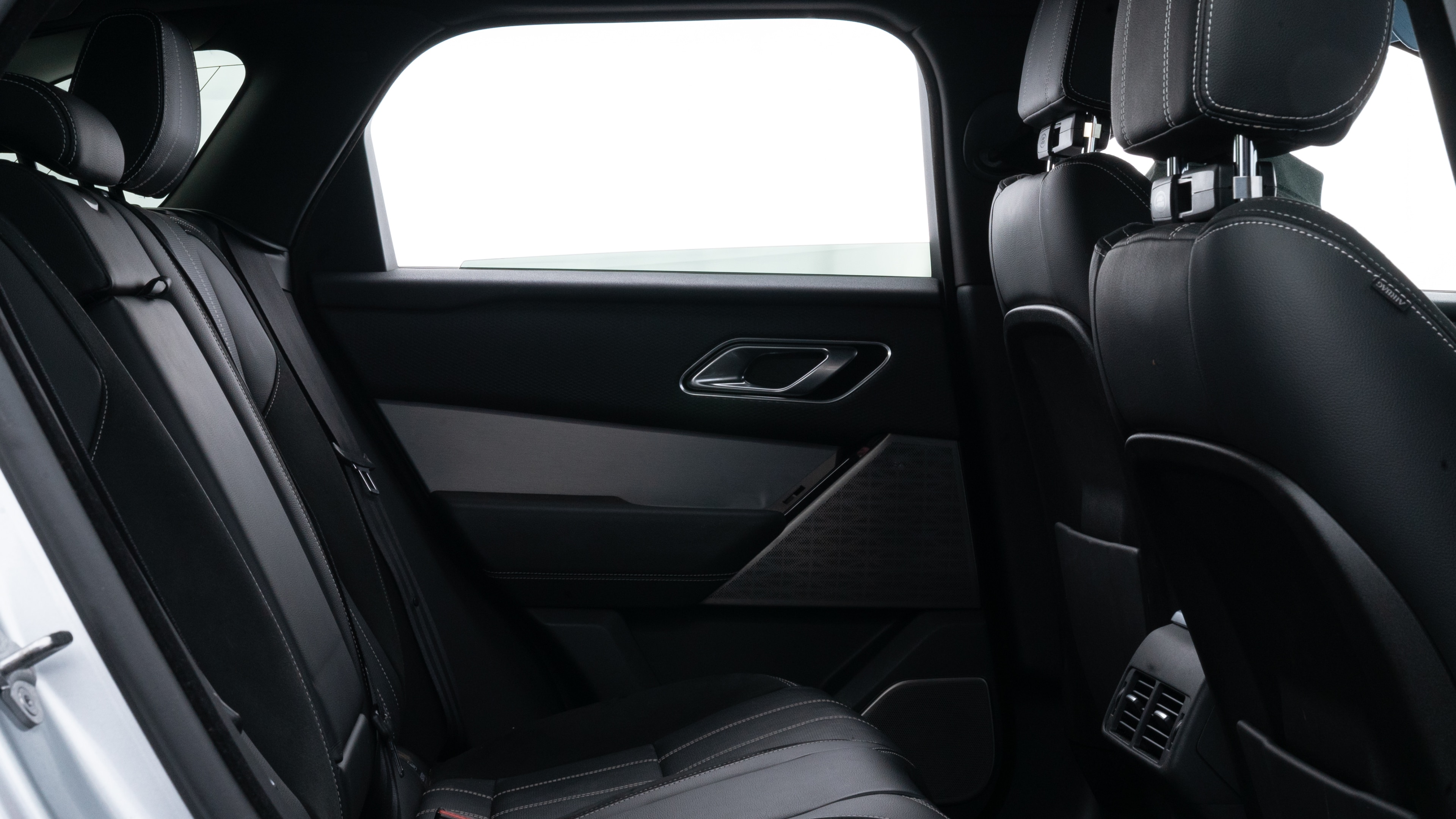 A series of second-row backseat photos is shown including one seating a baby seat and one seating a 6'1" mannequin.