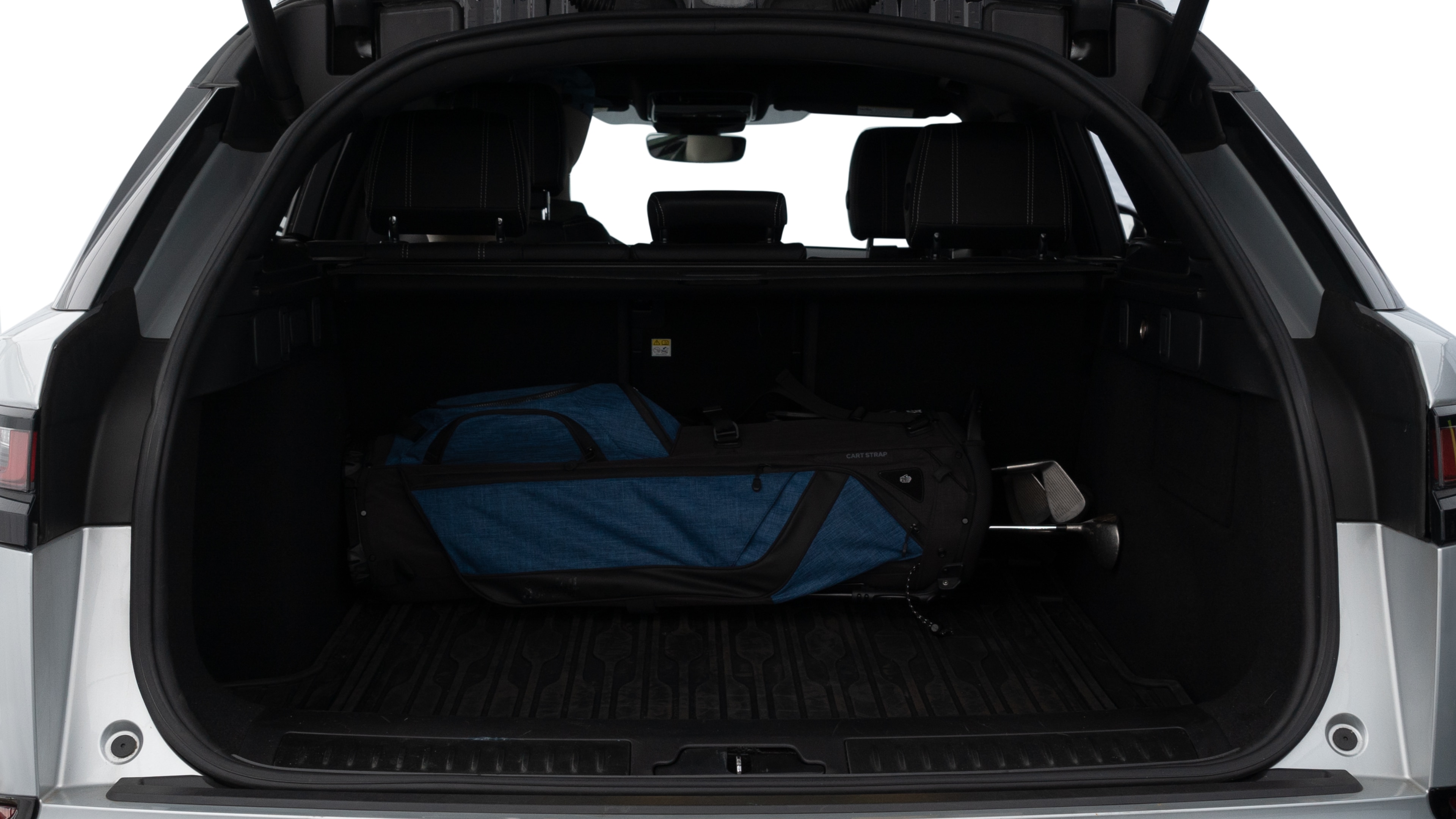 The trunk lid is open showing full view of the trunk. A baby stroller, three grocery carriers, two camping chairs in the carrying bag, and a set of golf clubs are placed inside.