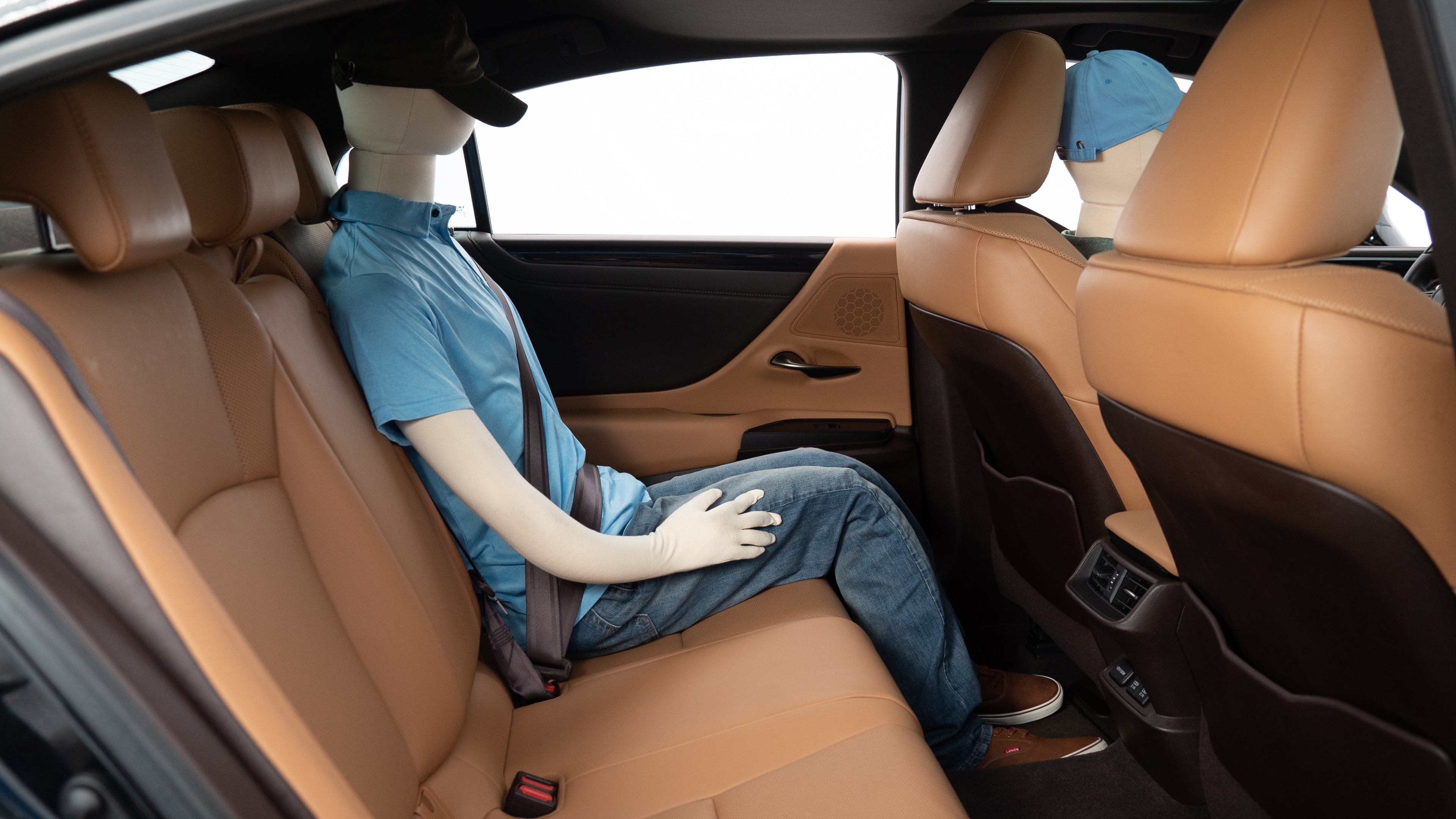 A series of second-row backseat photos is shown including one seating a baby seat, a dog and one seating a 6'1" mannequin.