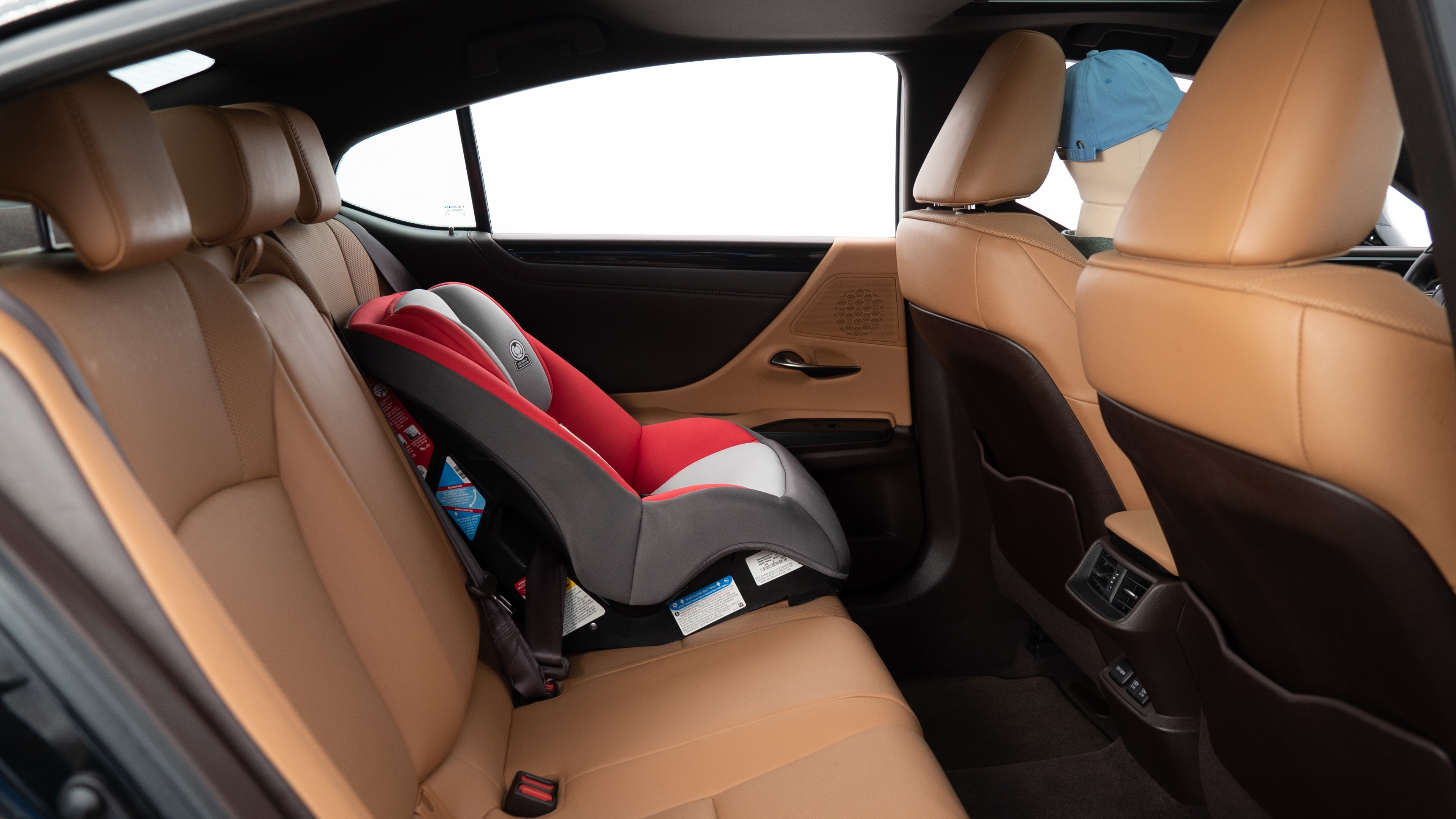 A series of second-row backseat photos is shown including one seating a baby seat, a dog and one seating a 6'1" mannequin.