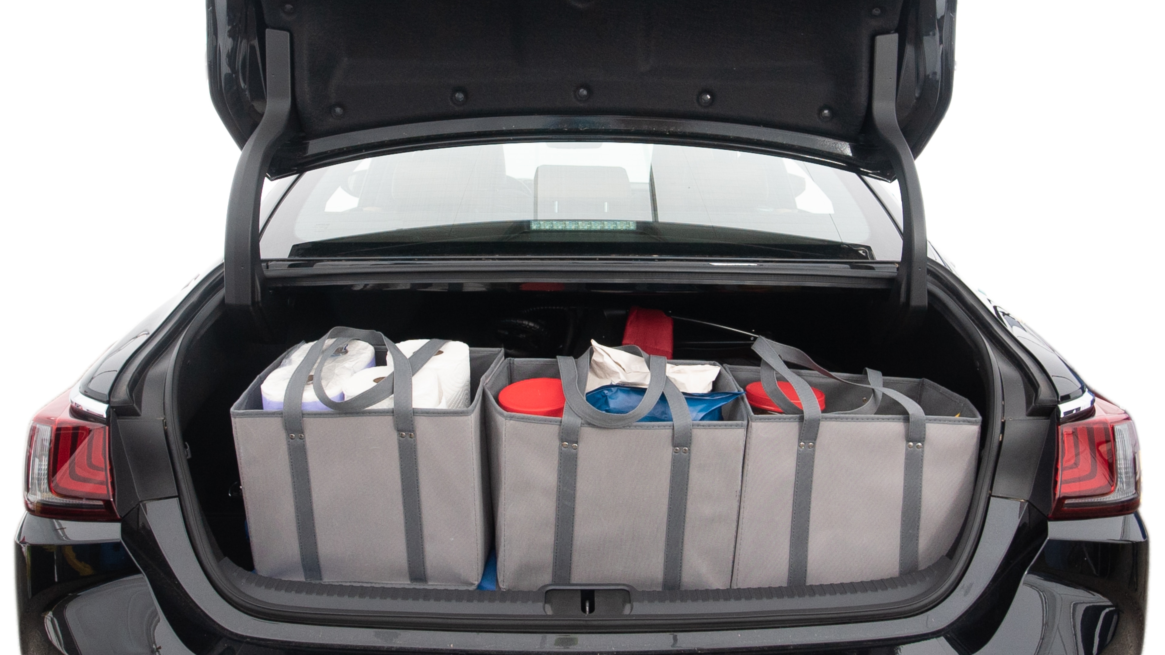 The trunk lid is open showing full view of the trunk. A baby stroller, three grocery carriers, two camping chairs in the carrying bag, and a set of golf clubs are placed inside.