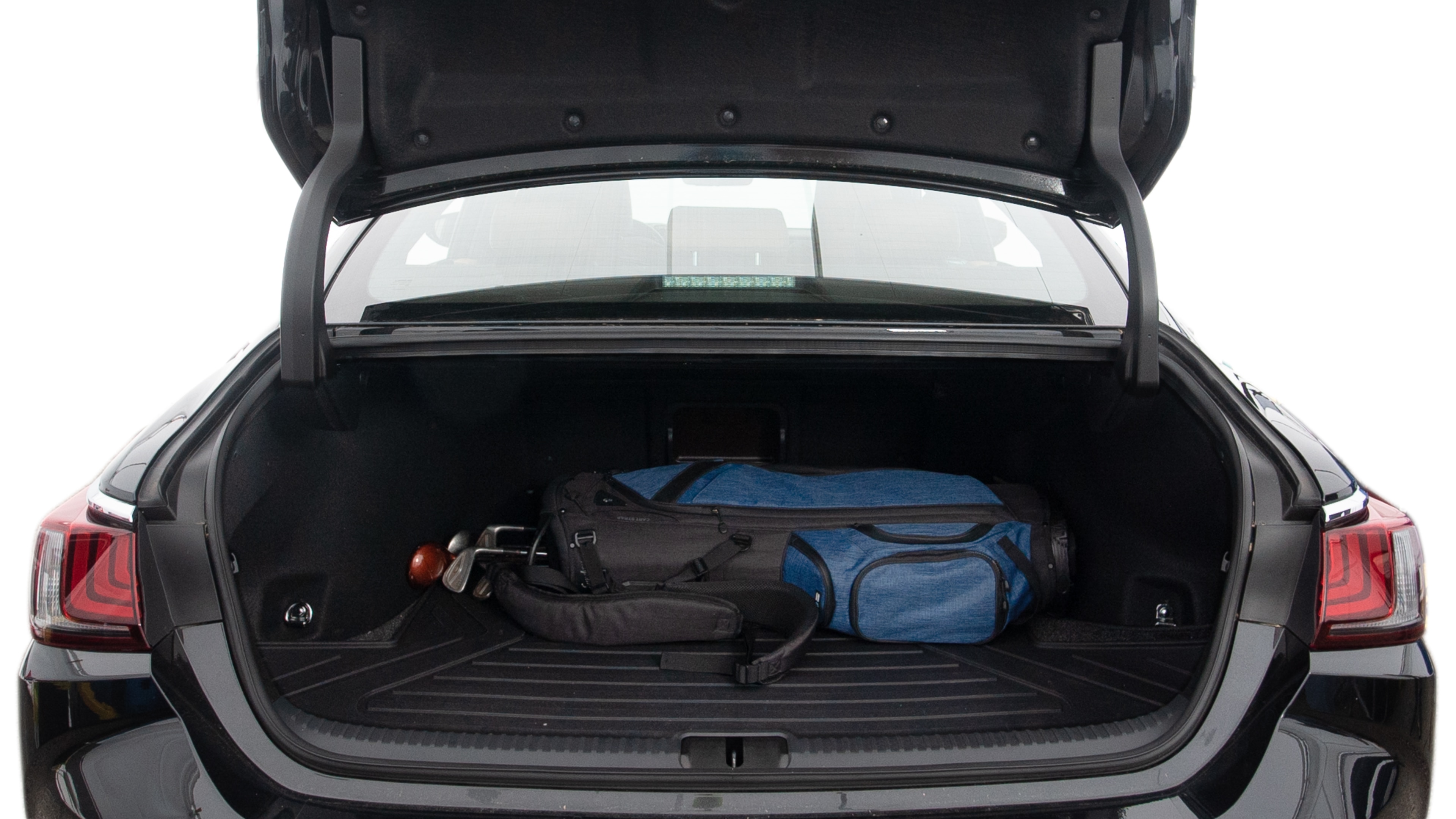 The trunk lid is open showing full view of the trunk. A baby stroller, three grocery carriers, two camping chairs in the carrying bag, and a set of golf clubs are placed inside.
