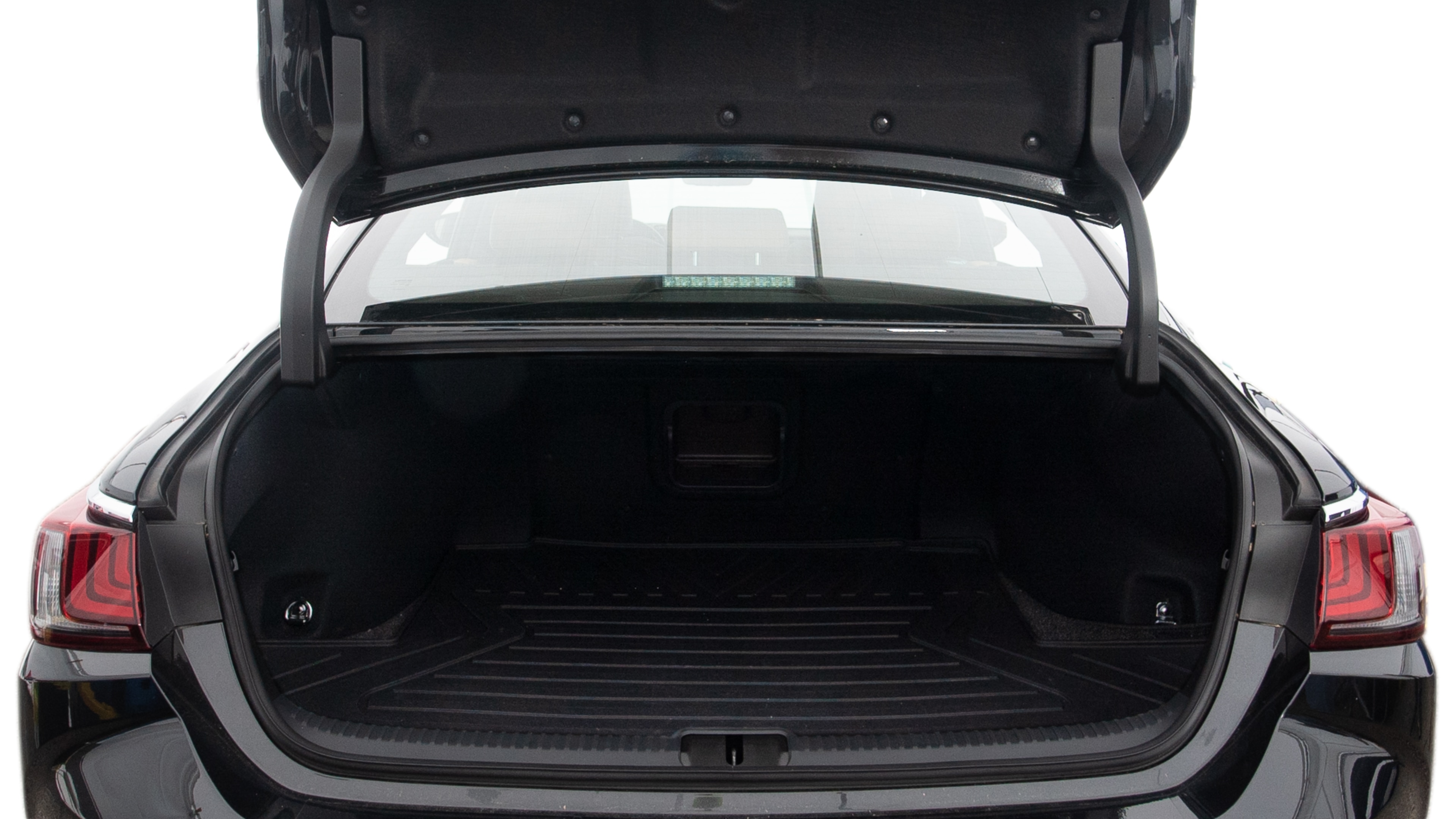 The trunk lid is open, showing full view of the trunk space. Two large and two small suitcases are placed inside.