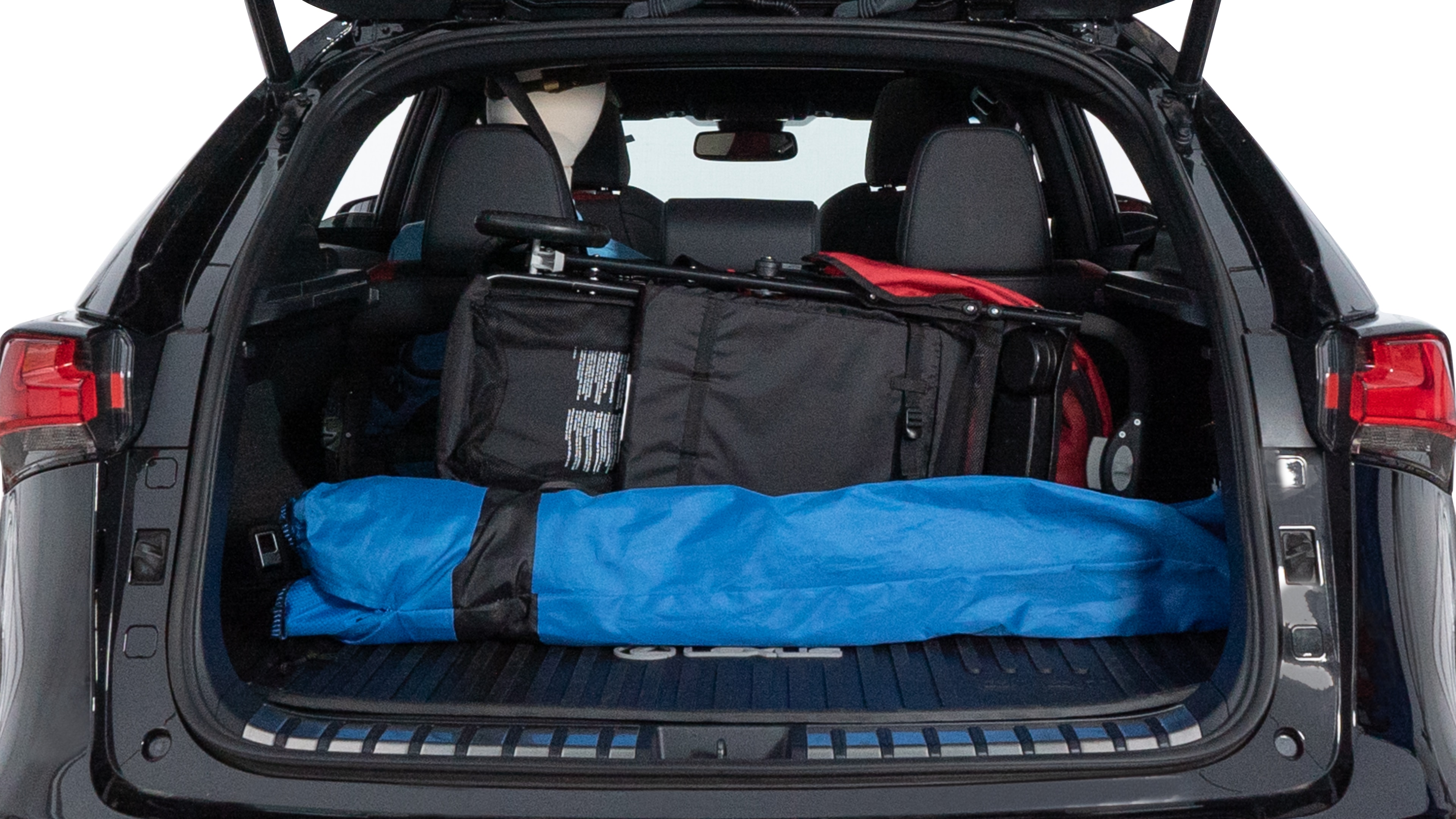 The trunk lid is open showing full view of the trunk. A baby stroller, three grocery carriers, two camping chairs in the carrying bag, and a set of golf clubs are placed inside.