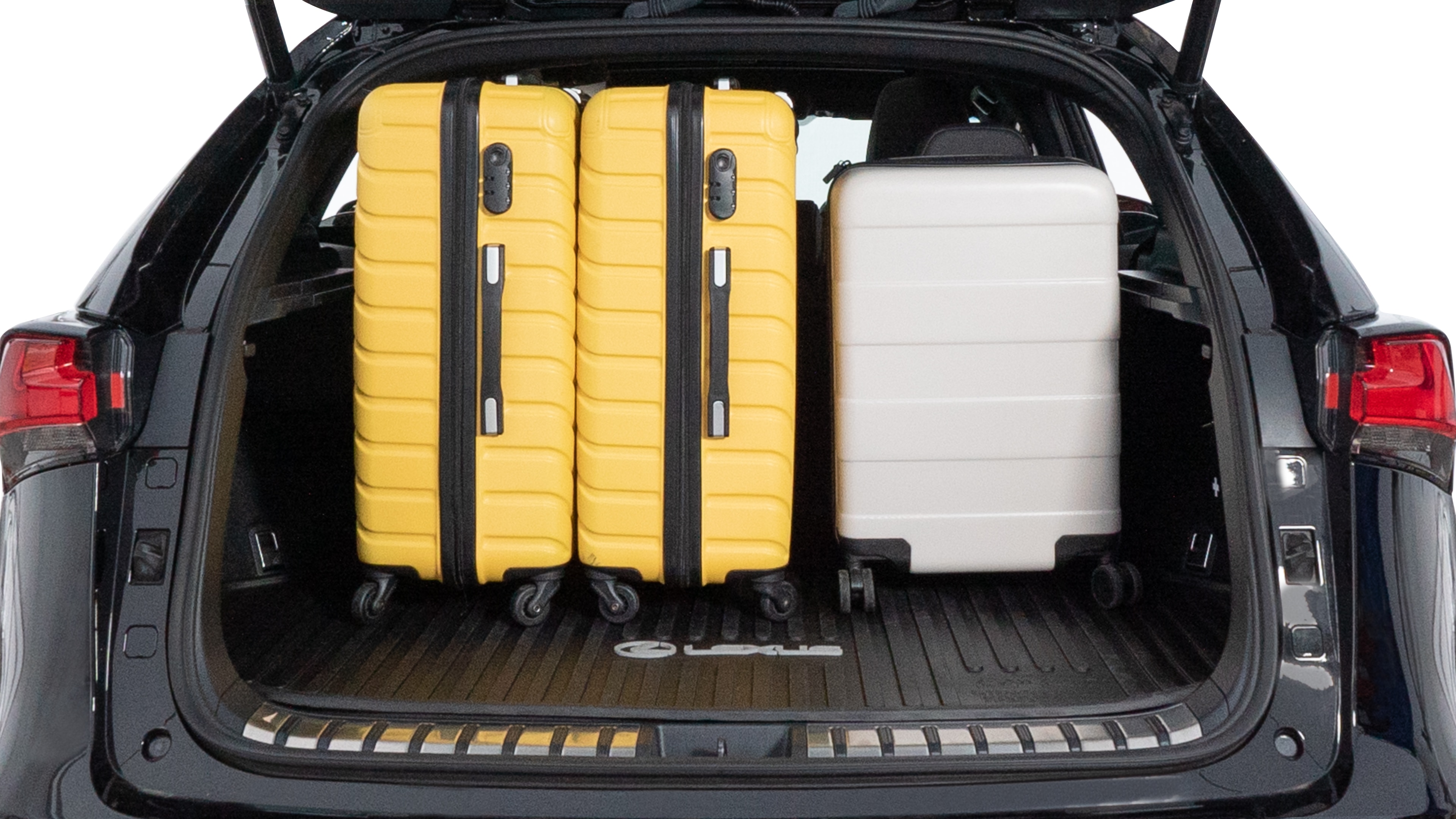 The trunk lid is open, showing full view of the trunk space. Two medium and two small suitcases are placed inside.