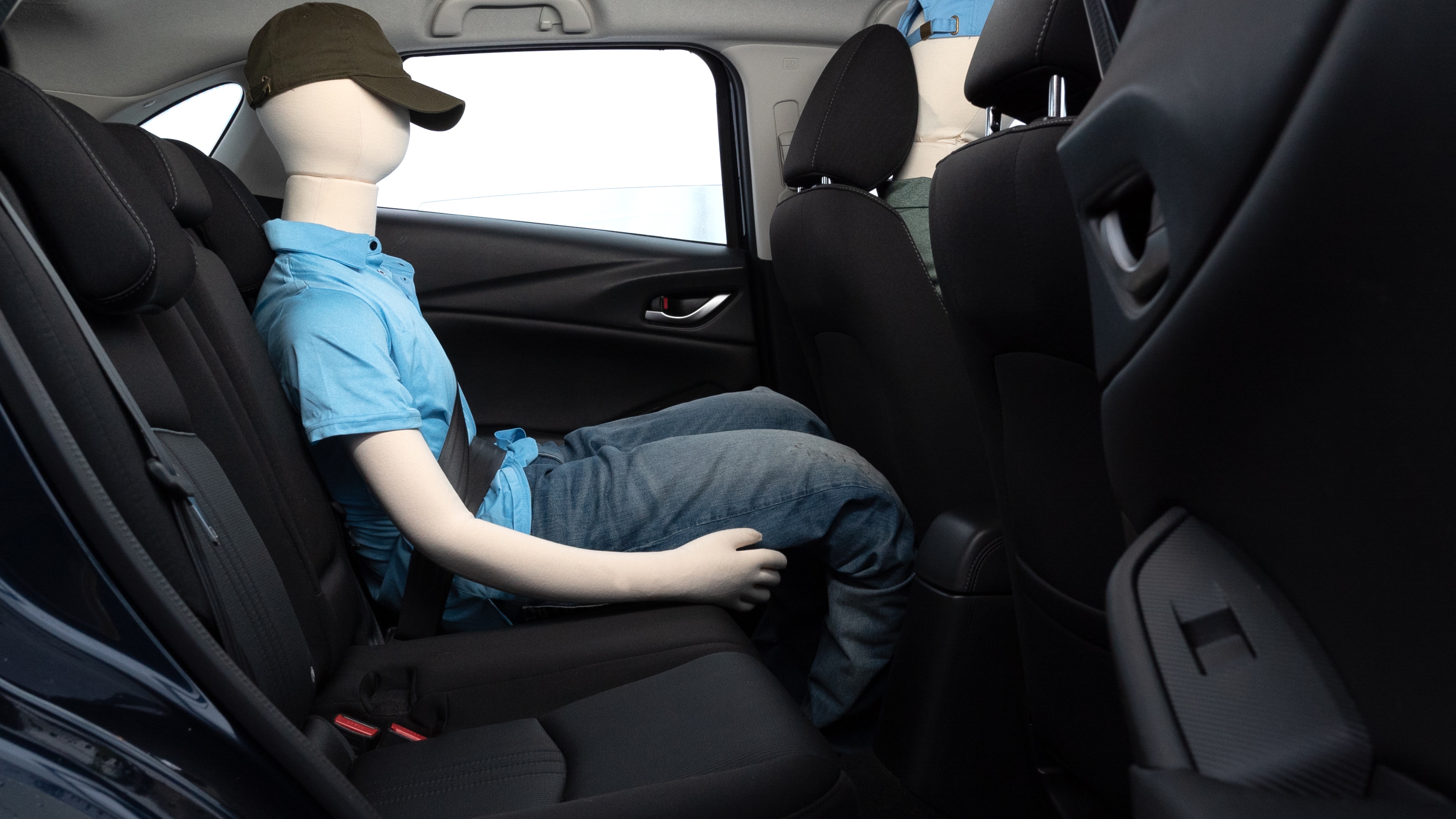 A series of second-row backseat photos is shown including one seating a baby seat and one seating a 6'1" mannequin.