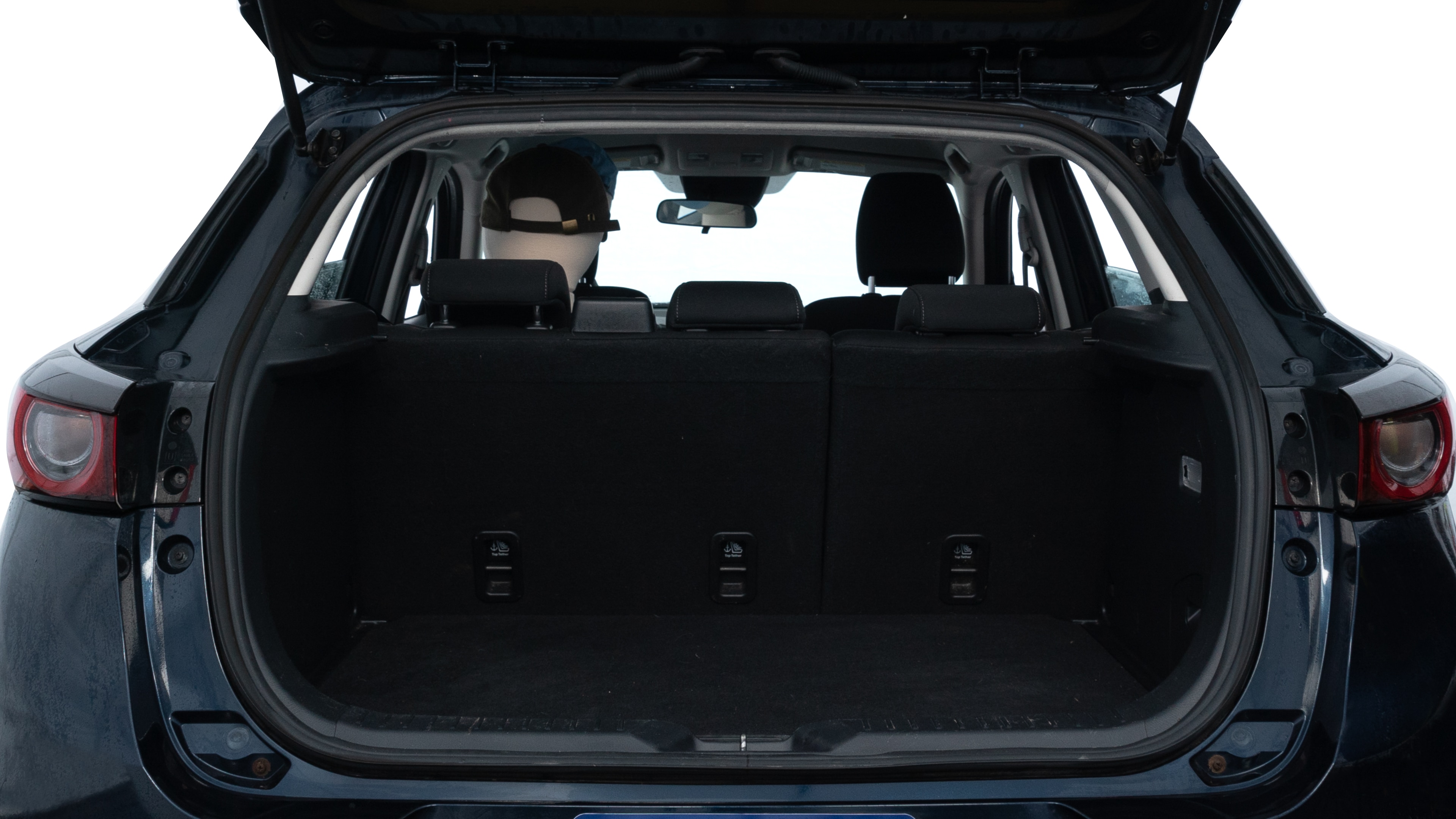 The trunk lid is open showing full view of the trunk. A baby stroller, three grocery carriers, two camping chairs in the carrying bag, and a set of golf clubs are placed inside.