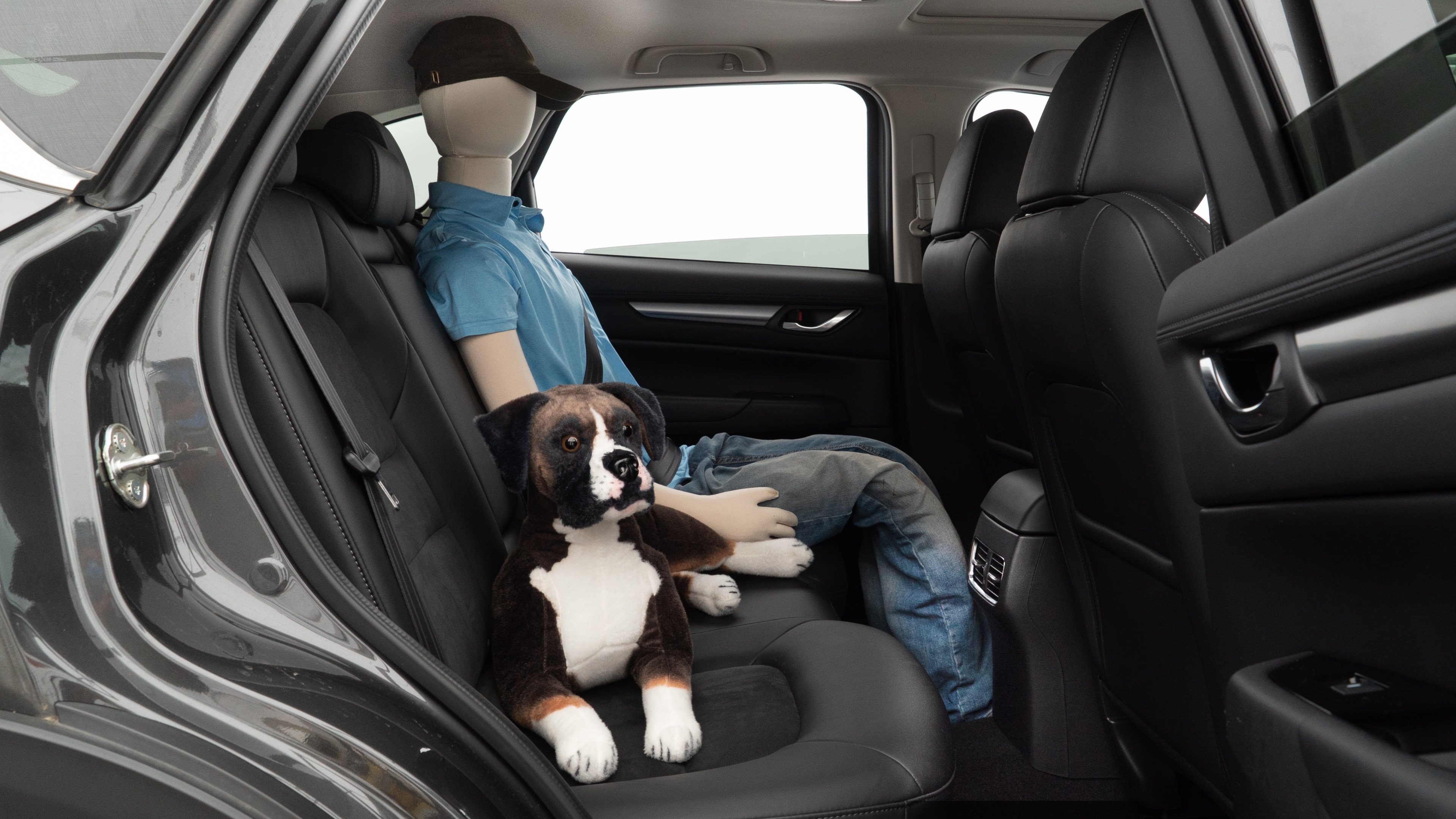 A series of second-row backseat photos is shown including one seating a baby seat and one seating a 6'1" mannequin.