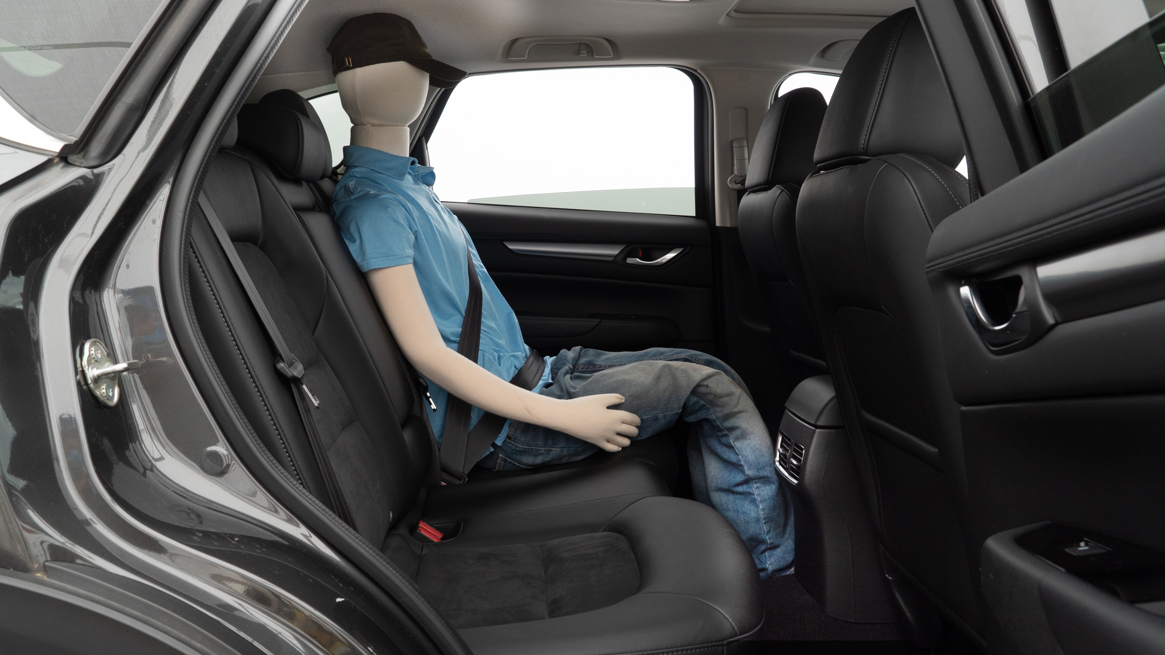 A series of second-row backseat photos is shown including one seating a baby seat and one seating a 6'1" mannequin.