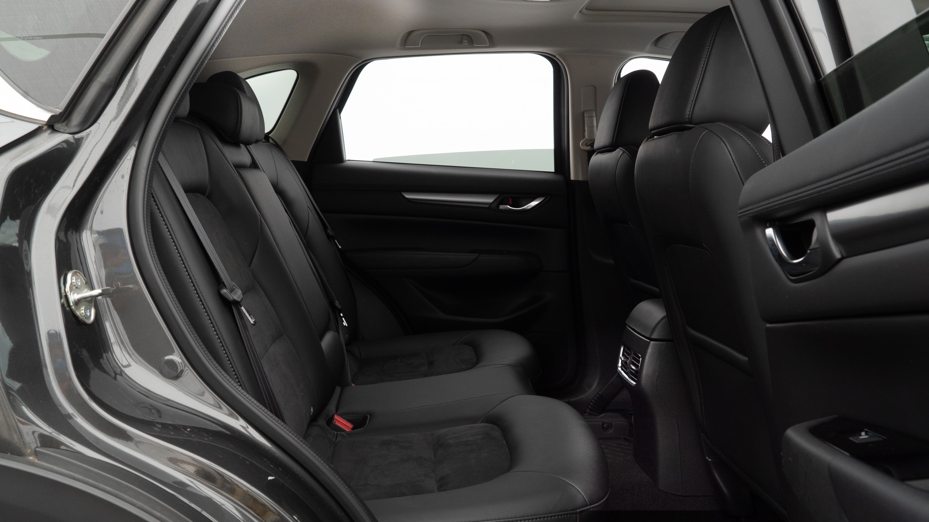 A series of second-row backseat photos is shown including one seating a baby seat and one seating a 6'1" mannequin.