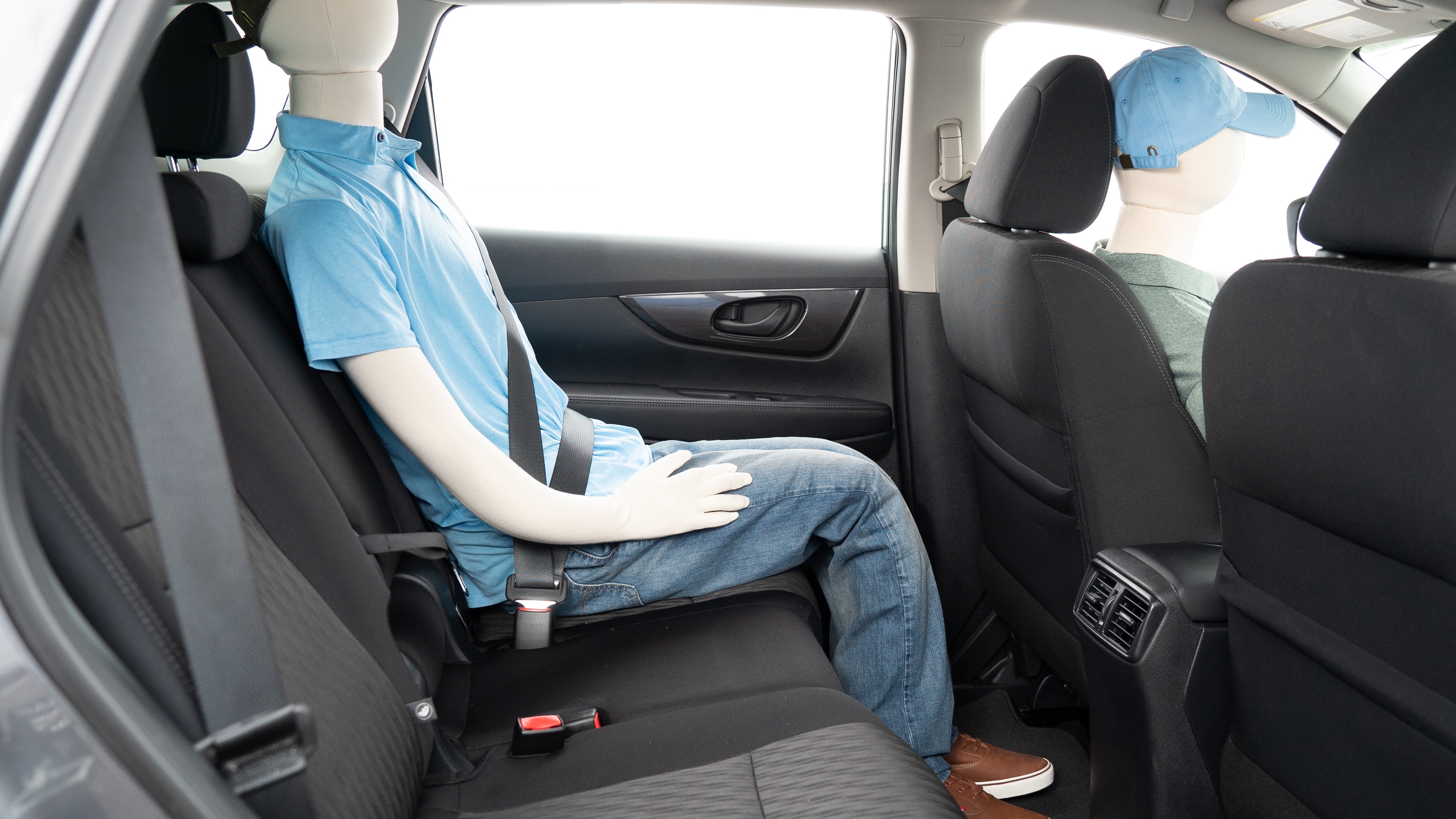 A series of second-row backseat photos is shown including one seating a baby seat and one seating a 6'1" mannequin.