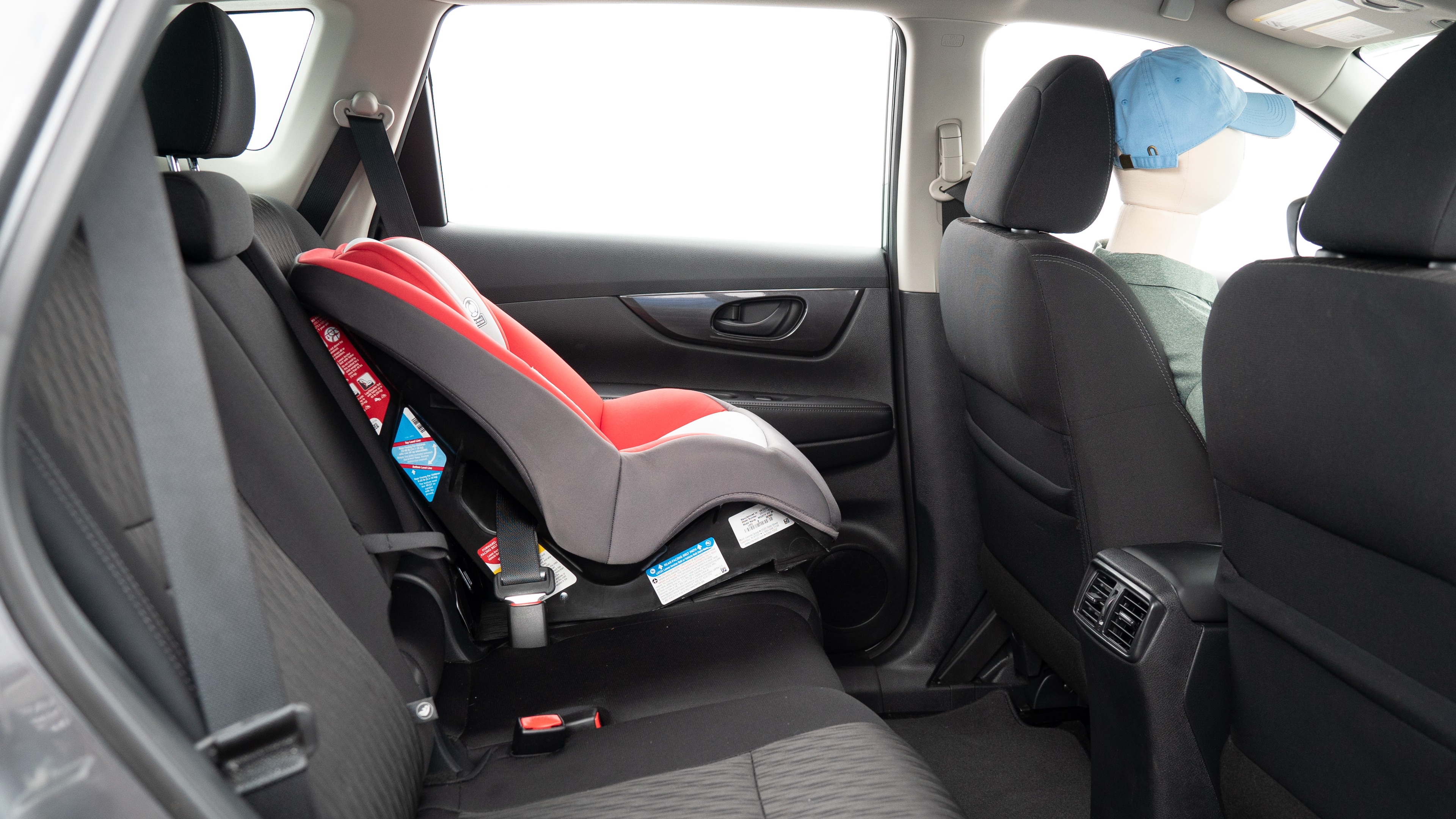 A series of second-row backseat photos is shown including one seating a baby seat and one seating a 6'1" mannequin.