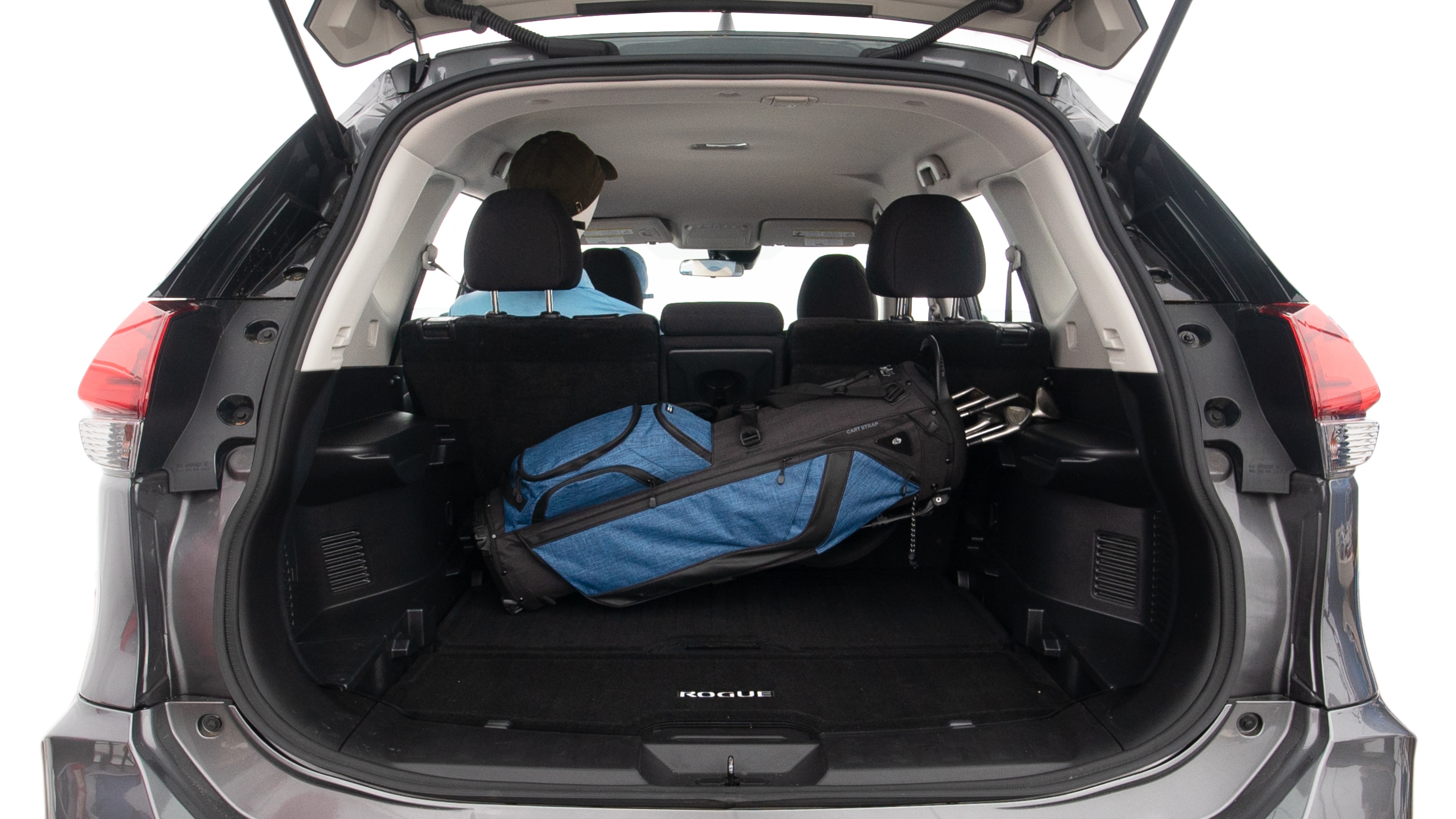 The trunk lid is open showing full view of the trunk. A baby stroller, three grocery carriers, two camping chairs in the carrying bag, and a set of golf clubs are placed inside.