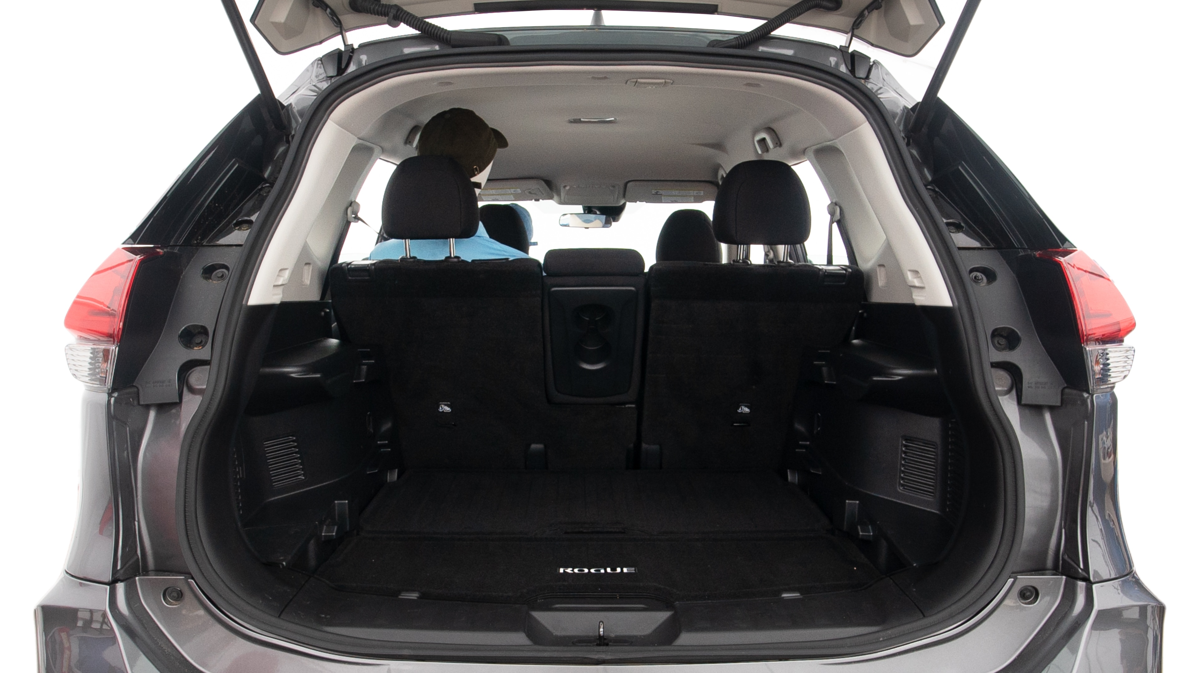 The trunk lid is open showing full view of the trunk. A baby stroller, three grocery carriers, two camping chairs in the carrying bag, and a set of golf clubs are placed inside.