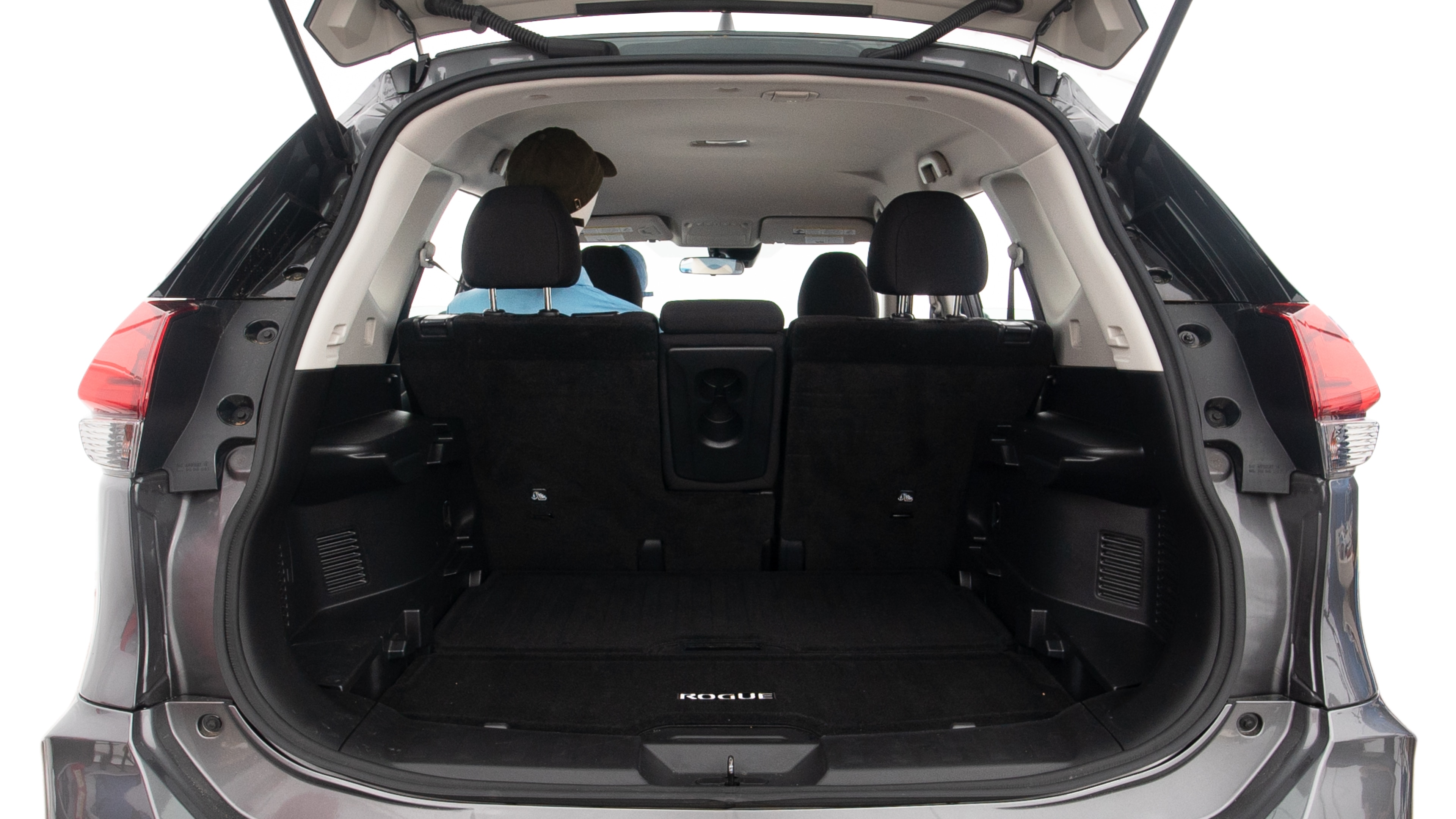 The trunk lid is open, showing full view of the trunk space. One extra large suitcase, two large suitcases and one small suitcases are placed inside.