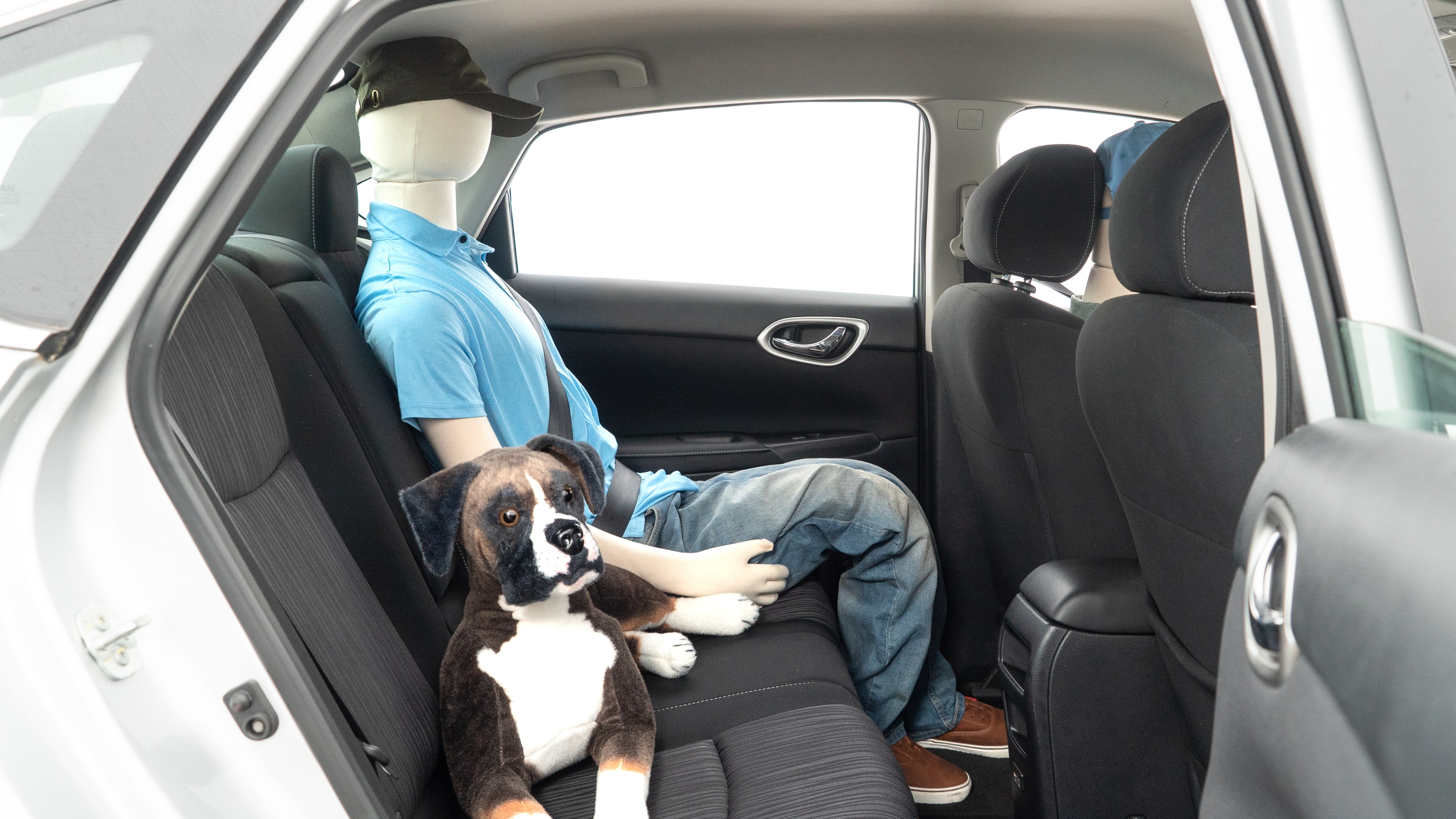 A series of second-row backseat photos is shown including one seating a baby seat and one seating a 6'1" mannequin.