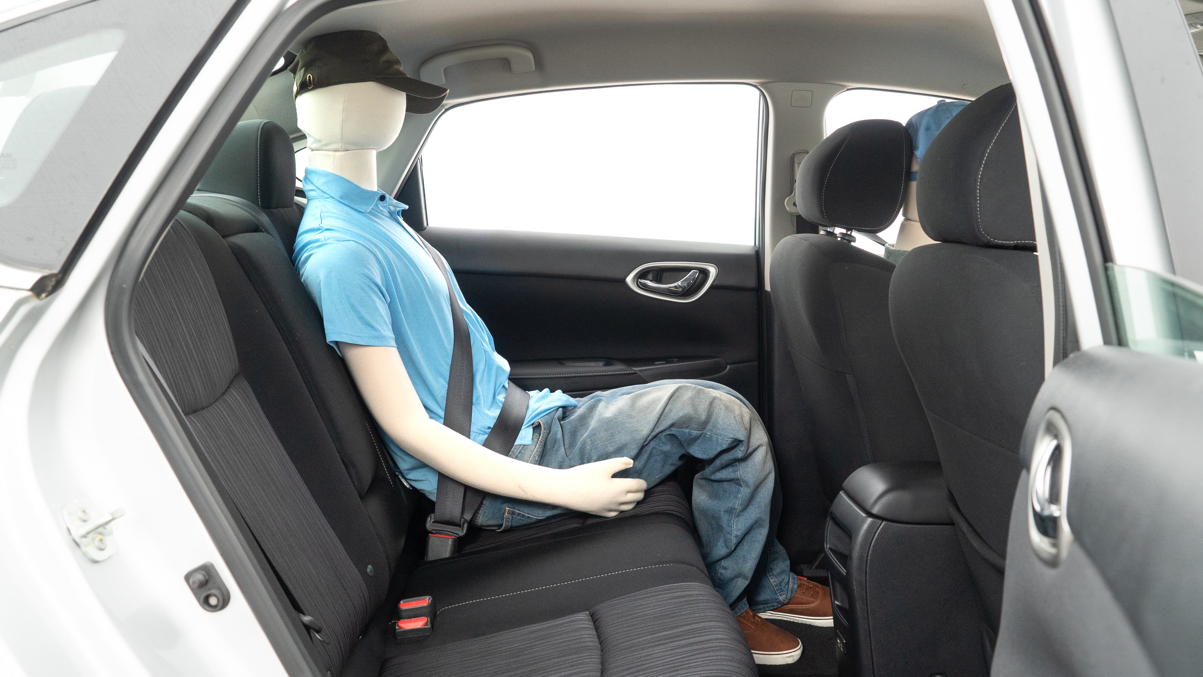 A series of second-row backseat photos is shown including one seating a baby seat and one seating a 6'1" mannequin.