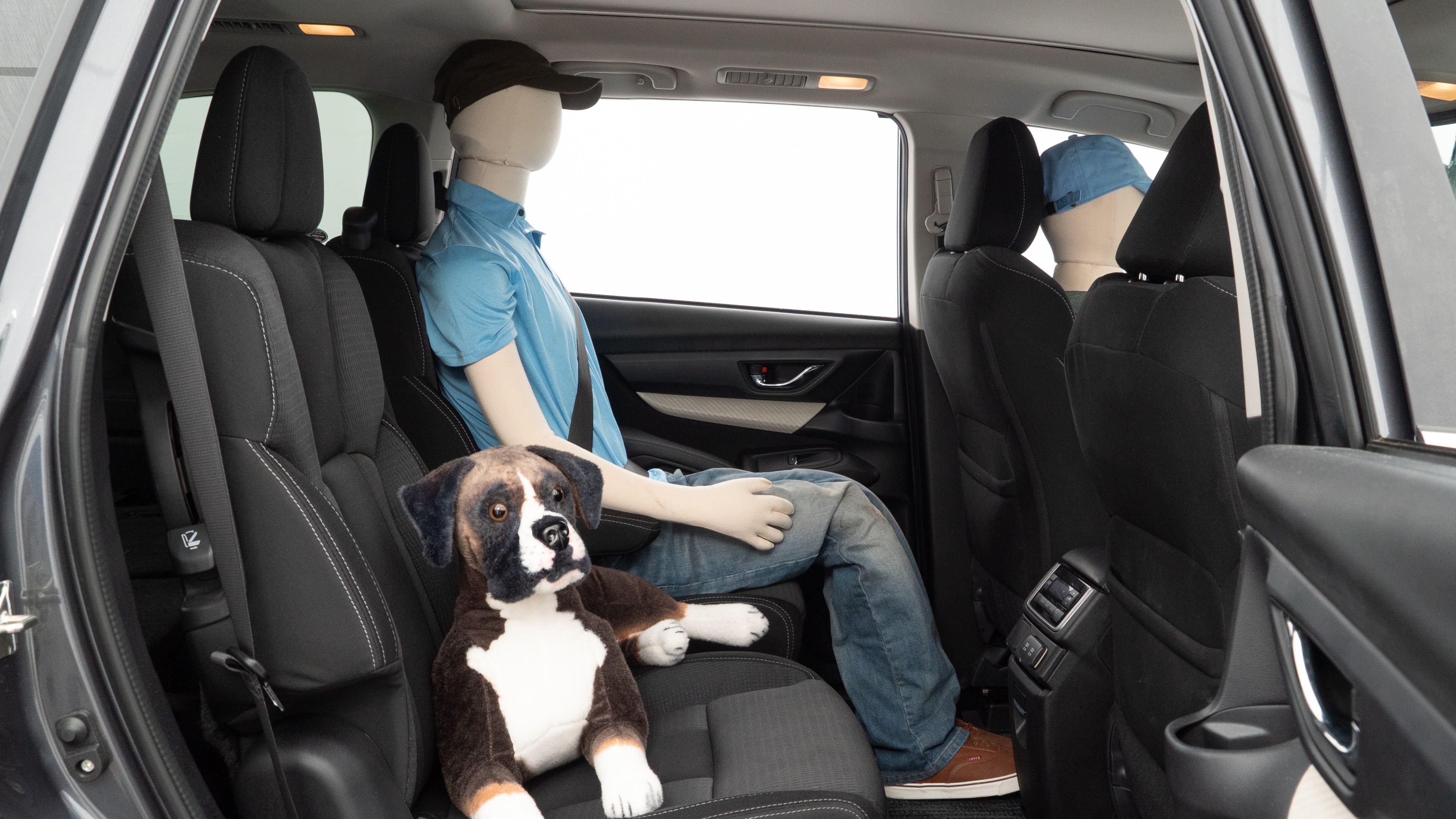 A series of second-row backseat photos is shown including one seating a baby seat and one seating a 6'1" mannequin