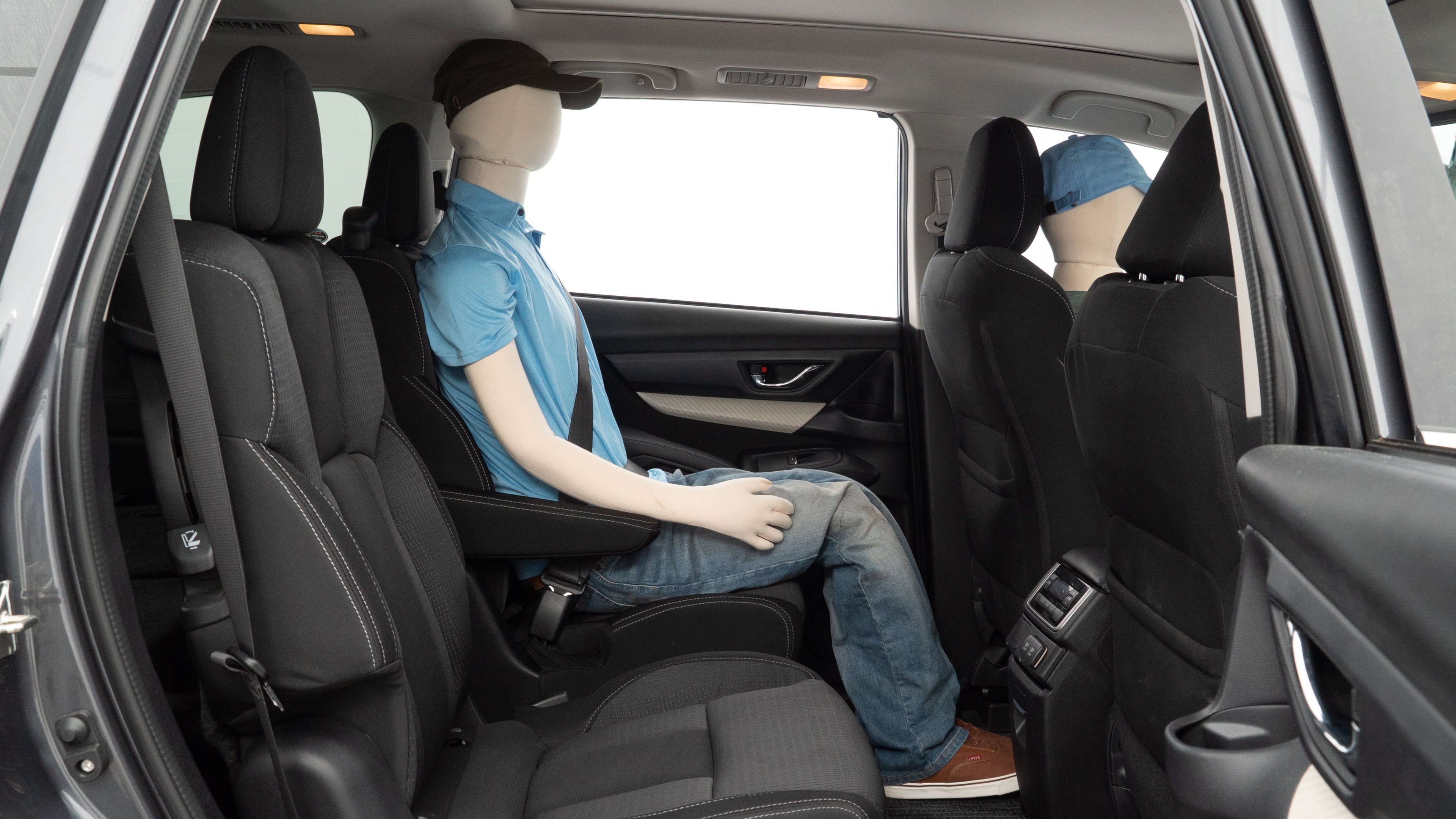 A series of second-row backseat photos is shown including one seating a baby seat and one seating a 6'1" mannequin