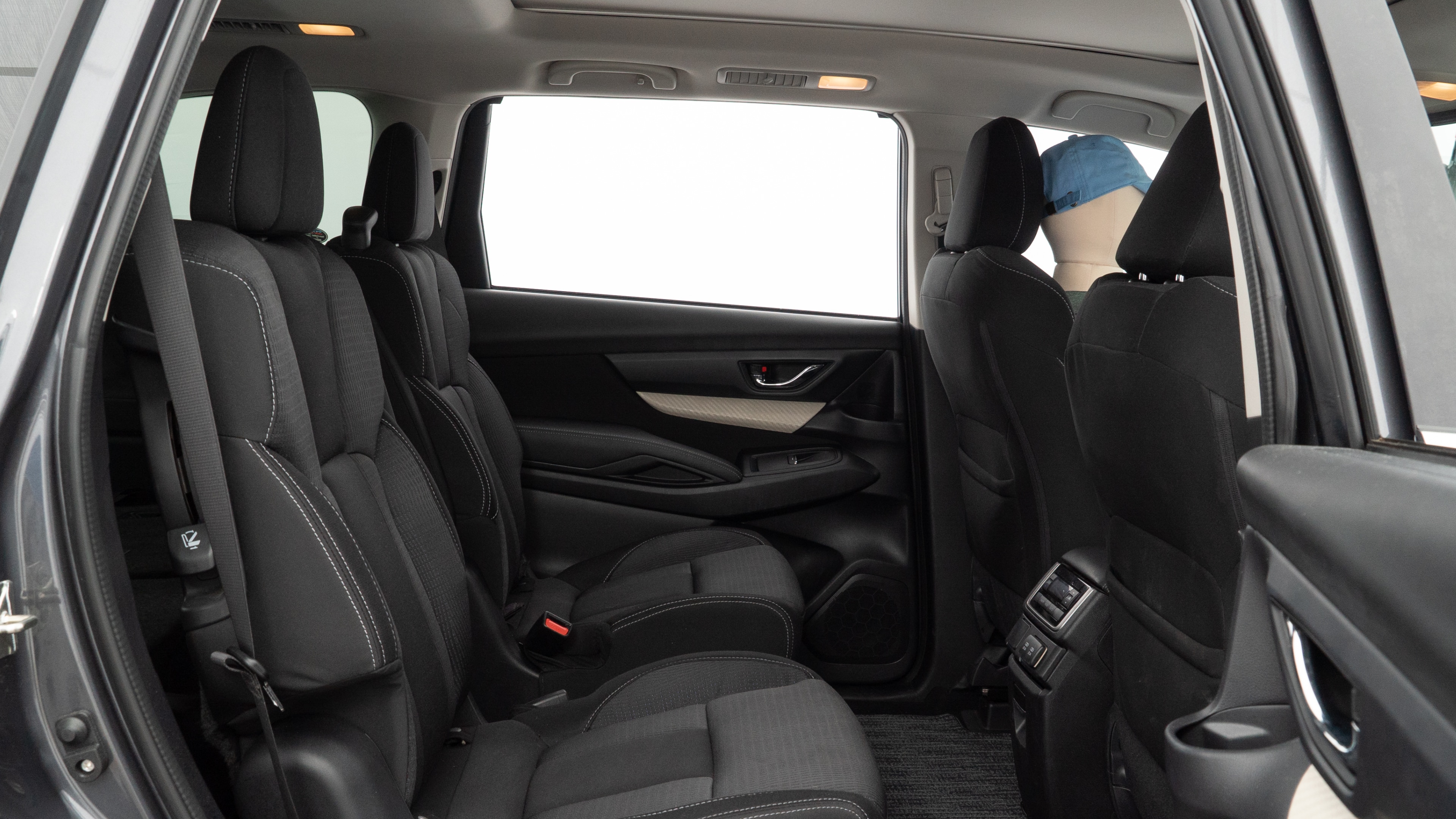 A series of second-row backseat photos is shown including one seating a baby seat and one seating a 6'1" mannequin