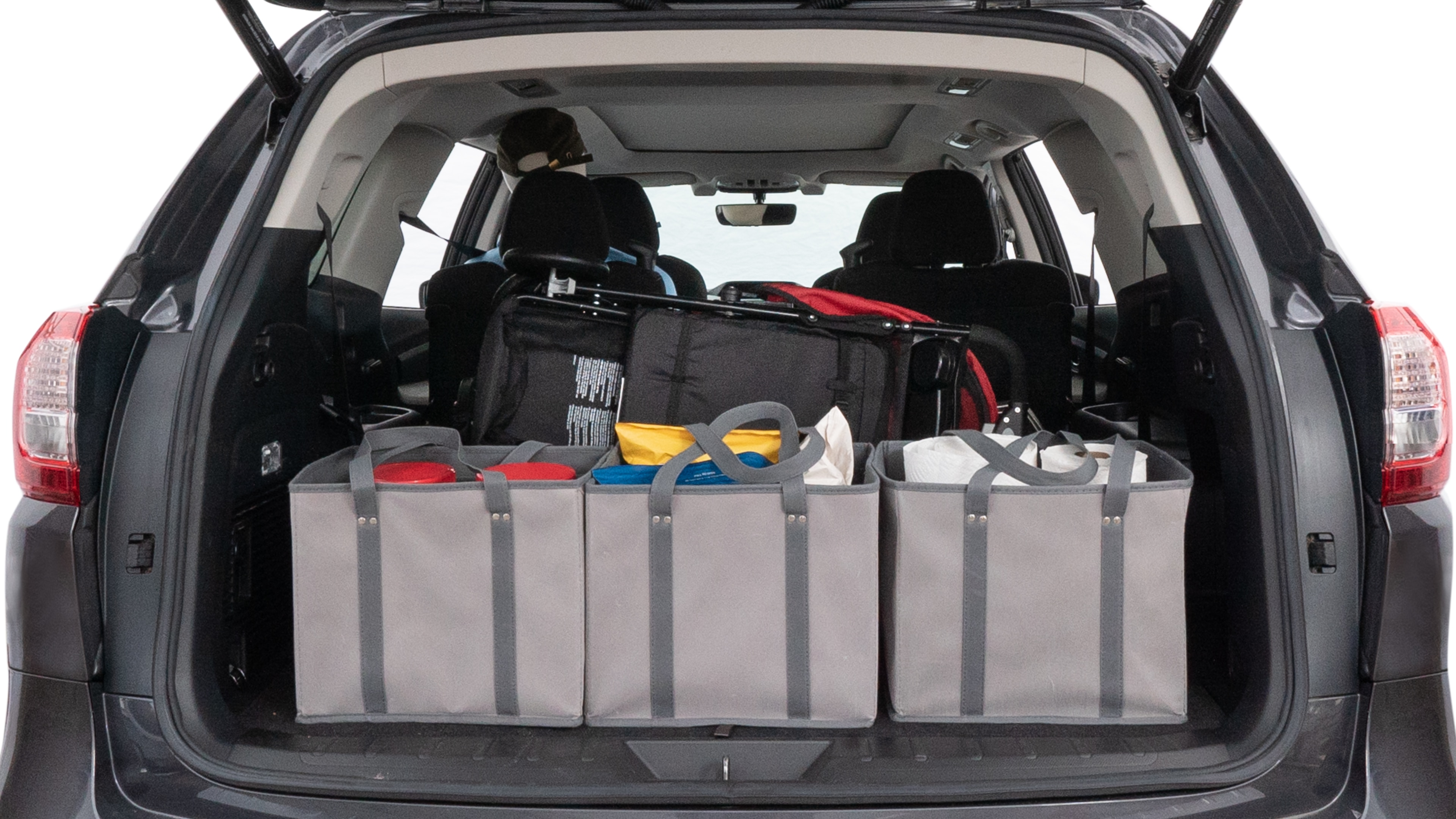 The trunk lid is open showing full view of the trunk. A baby stroller, three grocery carriers, two camping chairs in the carrying bag, and a set of golf clubs are placed inside.