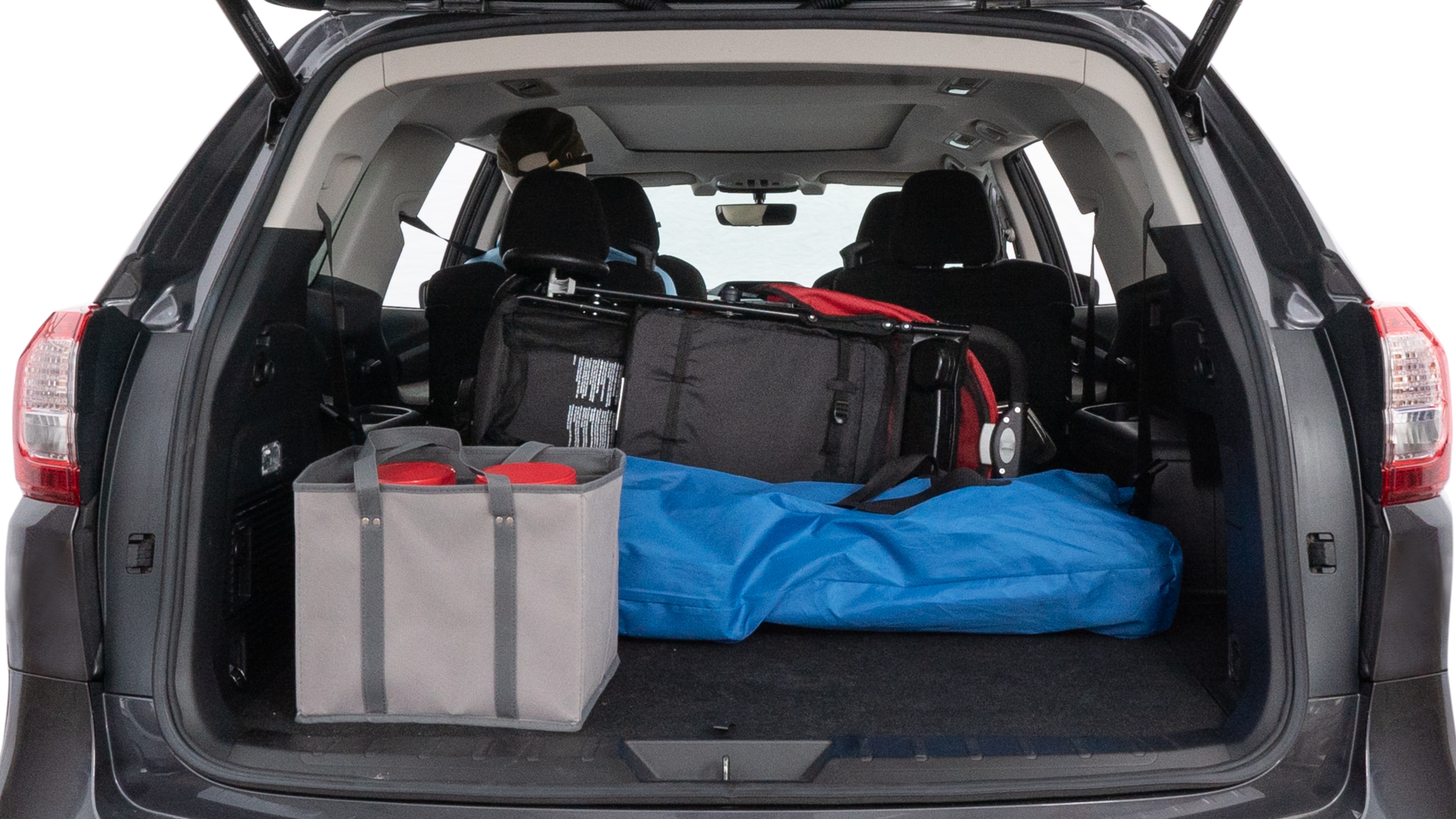 The trunk lid is open showing full view of the trunk. A baby stroller, three grocery carriers, two camping chairs in the carrying bag, and a set of golf clubs are placed inside.