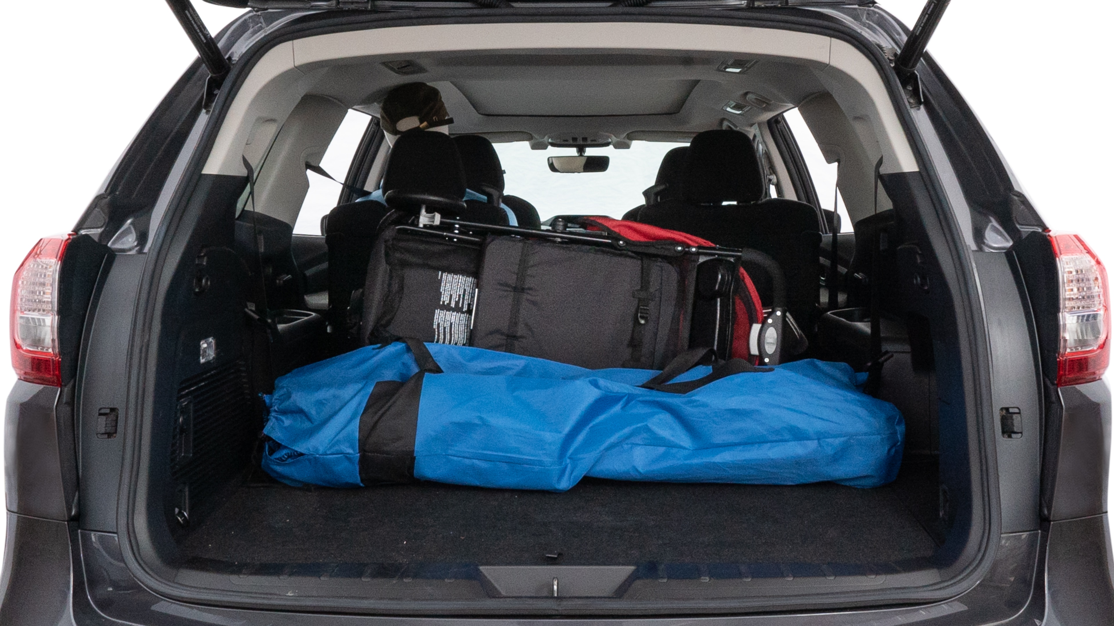 The trunk lid is open showing full view of the trunk. A baby stroller, three grocery carriers, two camping chairs in the carrying bag, and a set of golf clubs are placed inside.
