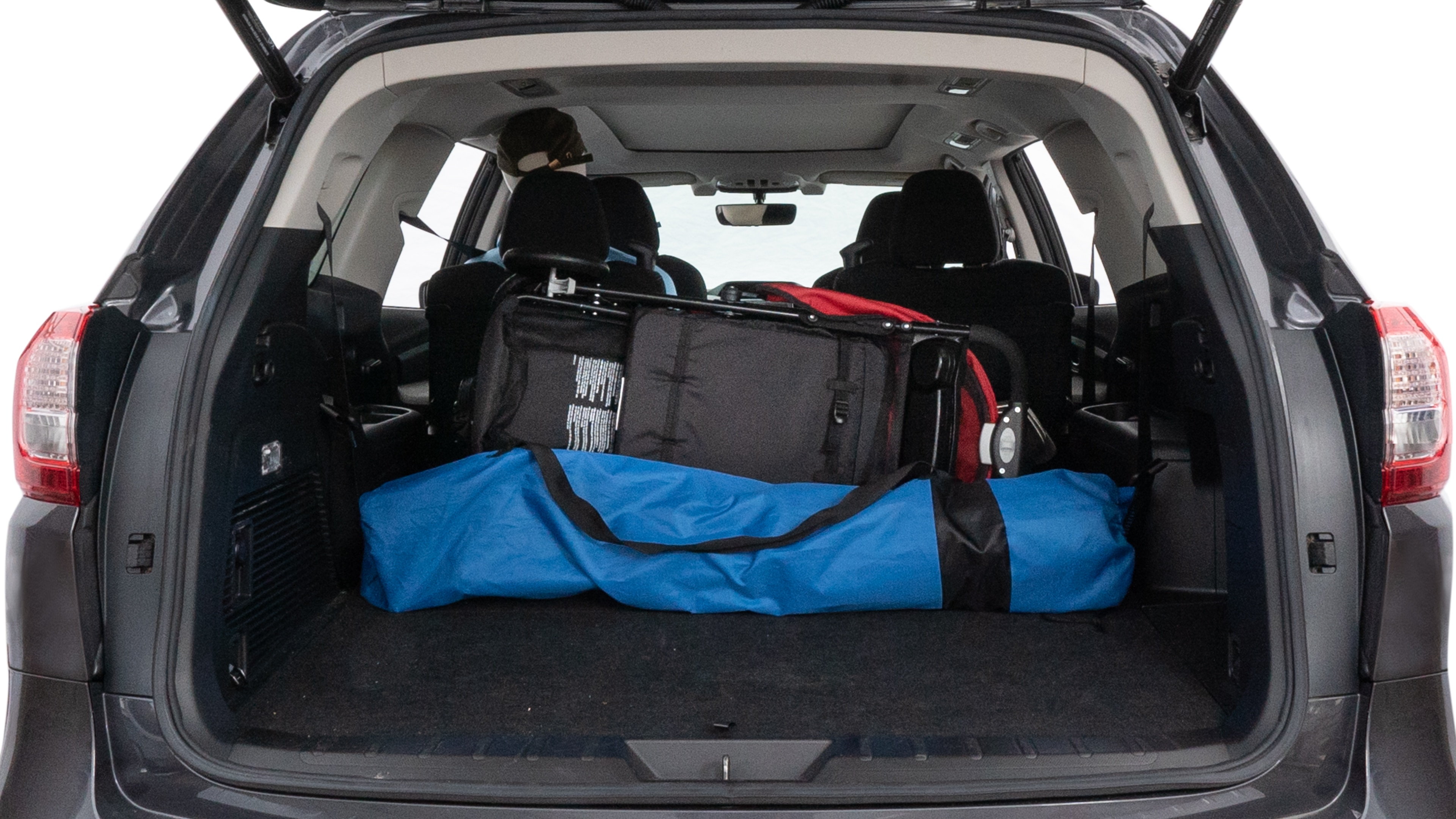 The trunk lid is open showing full view of the trunk. A baby stroller, three grocery carriers, two camping chairs in the carrying bag, and a set of golf clubs are placed inside.