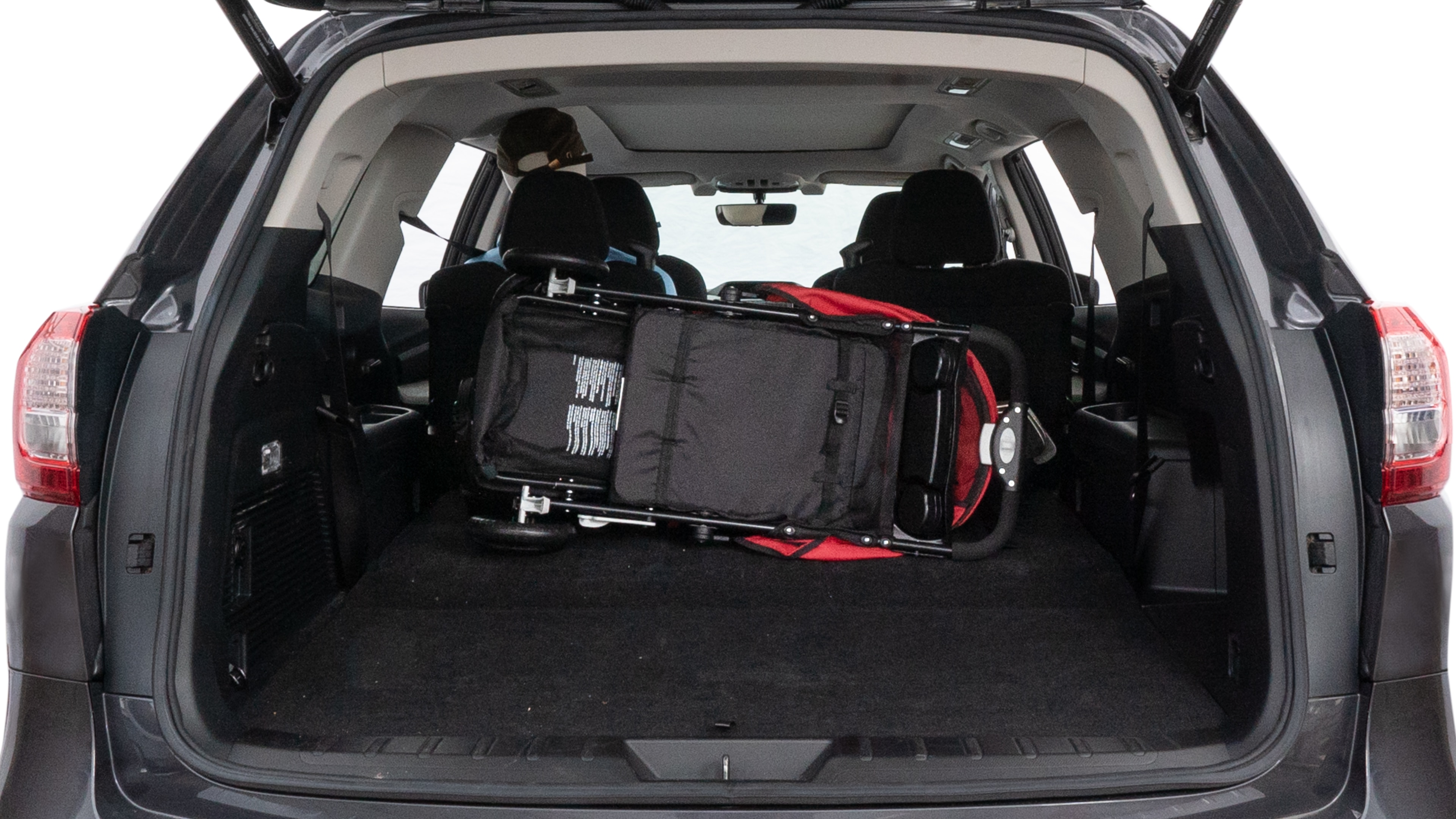 The trunk lid is open showing full view of the trunk. A baby stroller, three grocery carriers, two camping chairs in the carrying bag, and a set of golf clubs are placed inside.