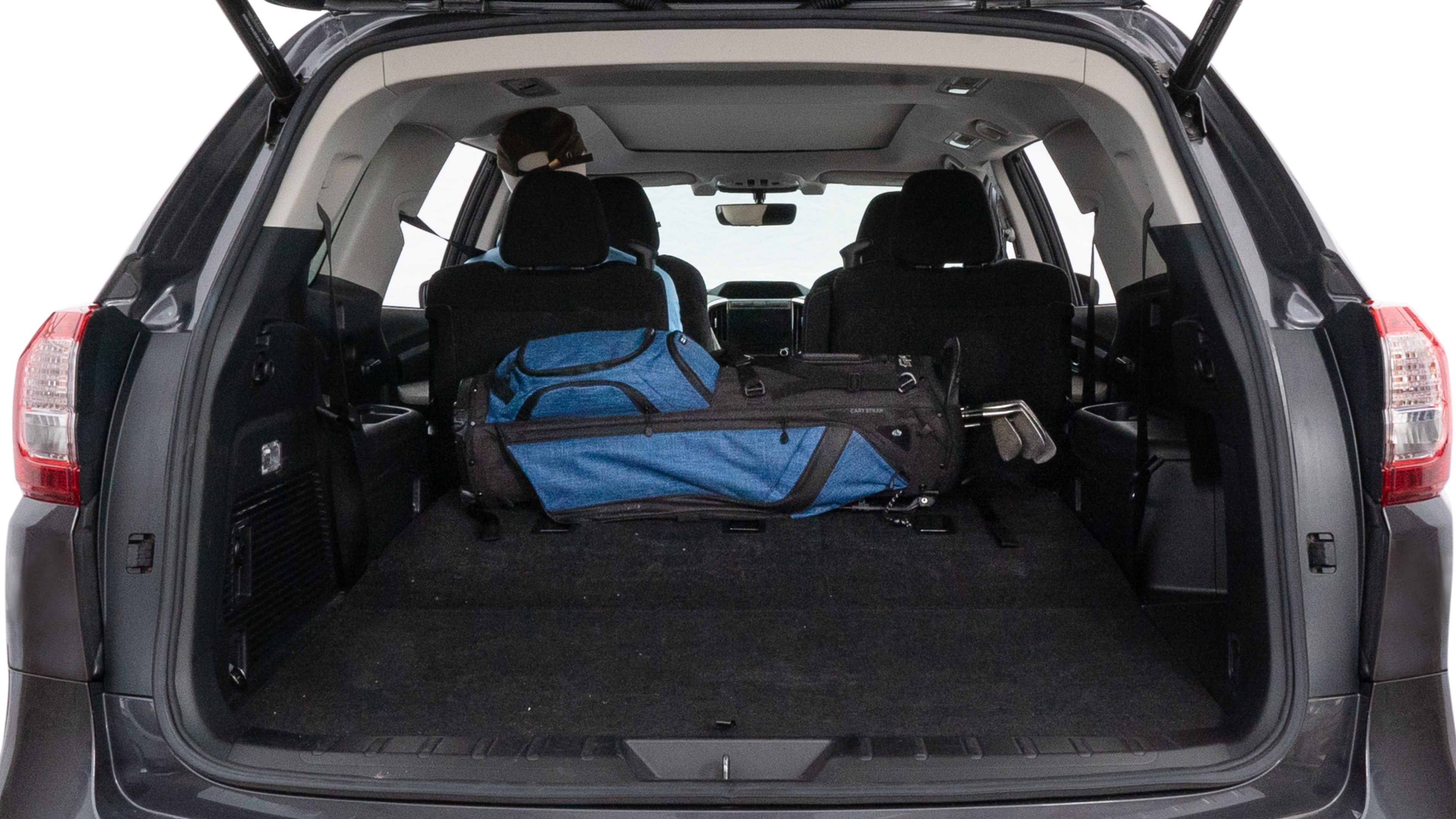 The trunk lid is open showing full view of the trunk. A baby stroller, three grocery carriers, two camping chairs in the carrying bag, and a set of golf clubs are placed inside.