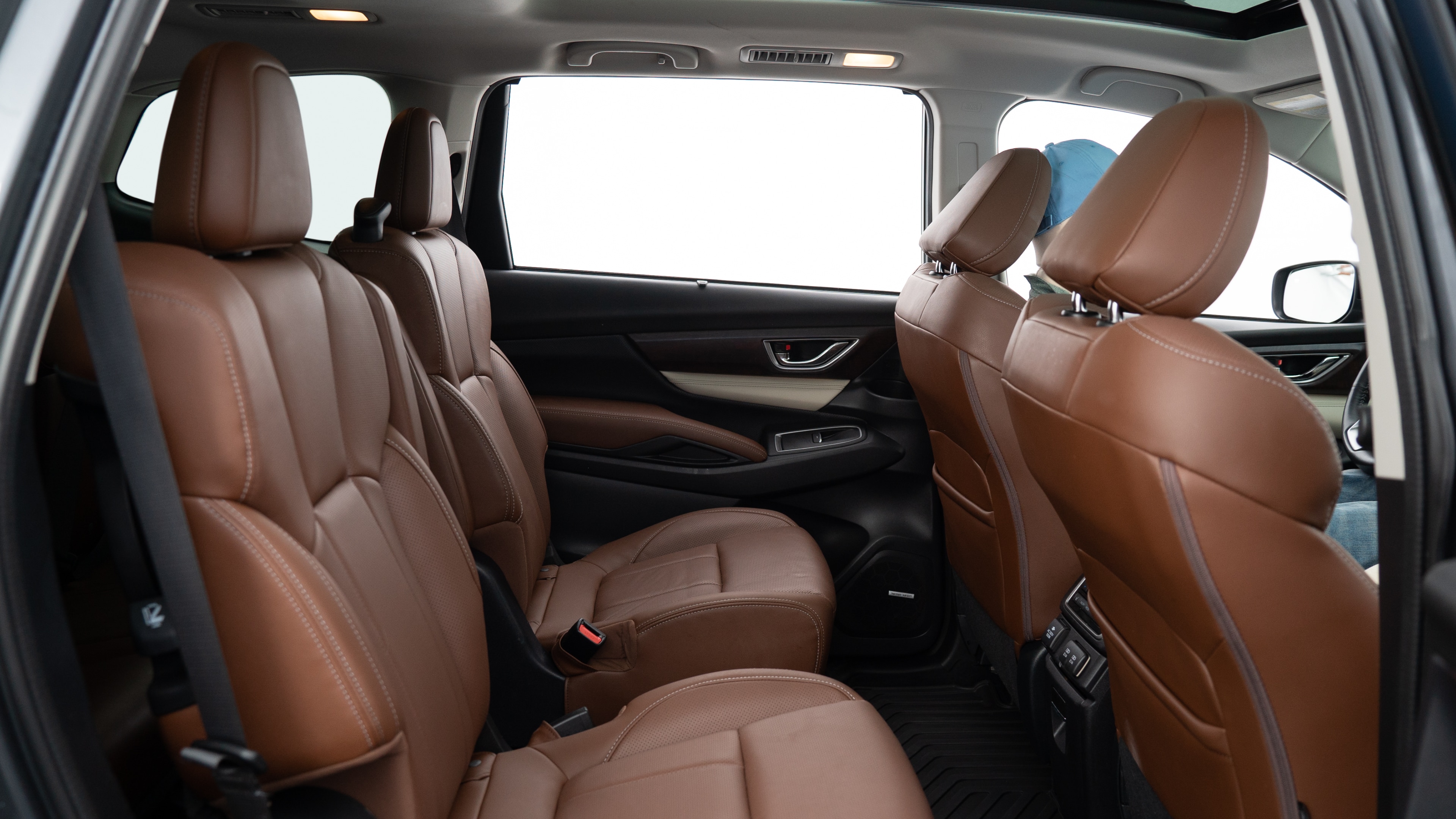 A series of second-row backseat photos is shown including one seating a baby seat, a dog and one seating a 6'1" mannequin.