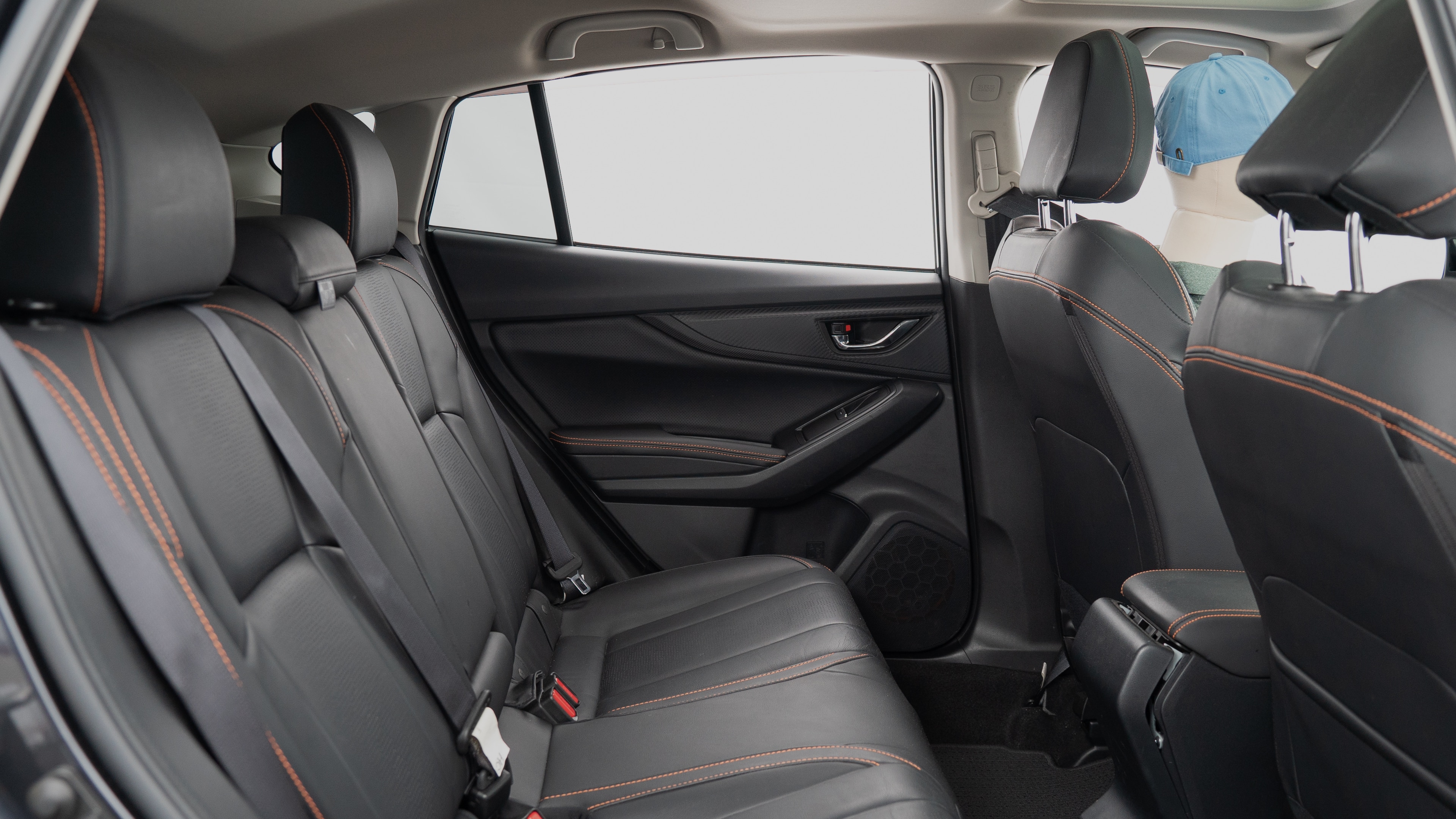 A series of second-row backseat photos is shown including one seating a baby seat, a dog and one seating a 6'1" mannequin.