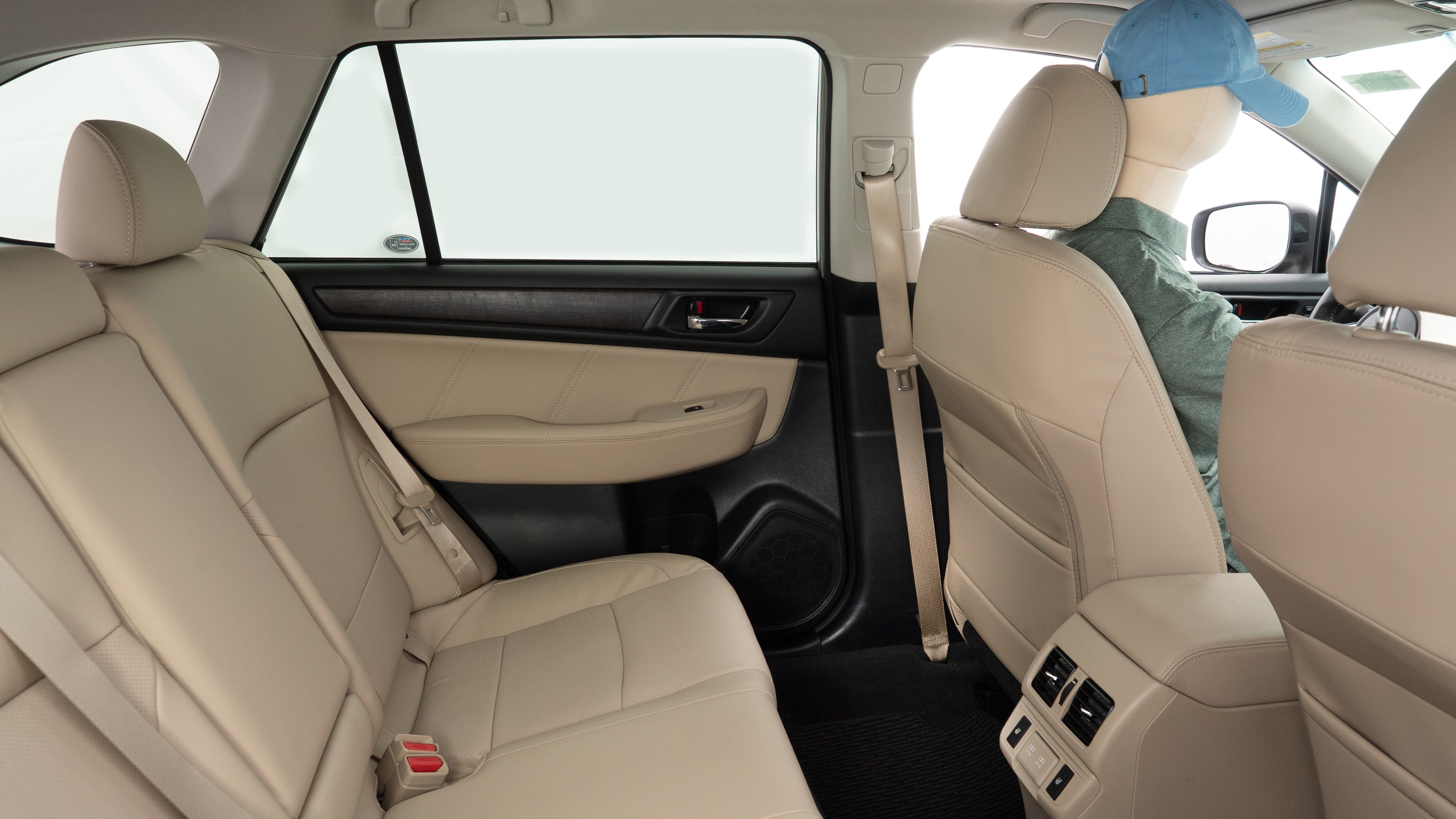 A series of second-row backseat photos is shown including one seating a baby seat and one seating a 6'1" mannequin.