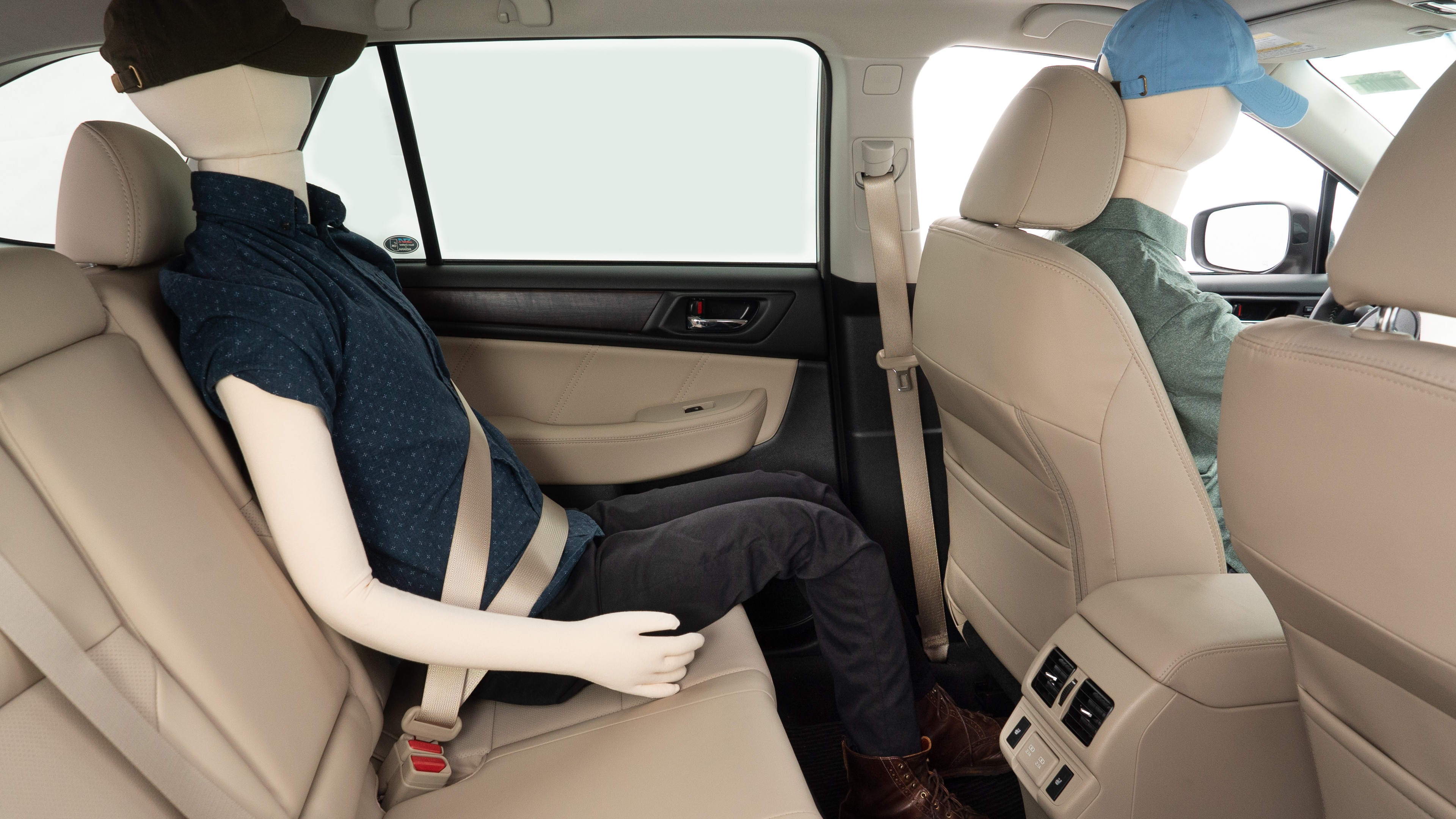 A series of second-row backseat photos is shown including one seating a baby seat and one seating a 6'1" mannequin.