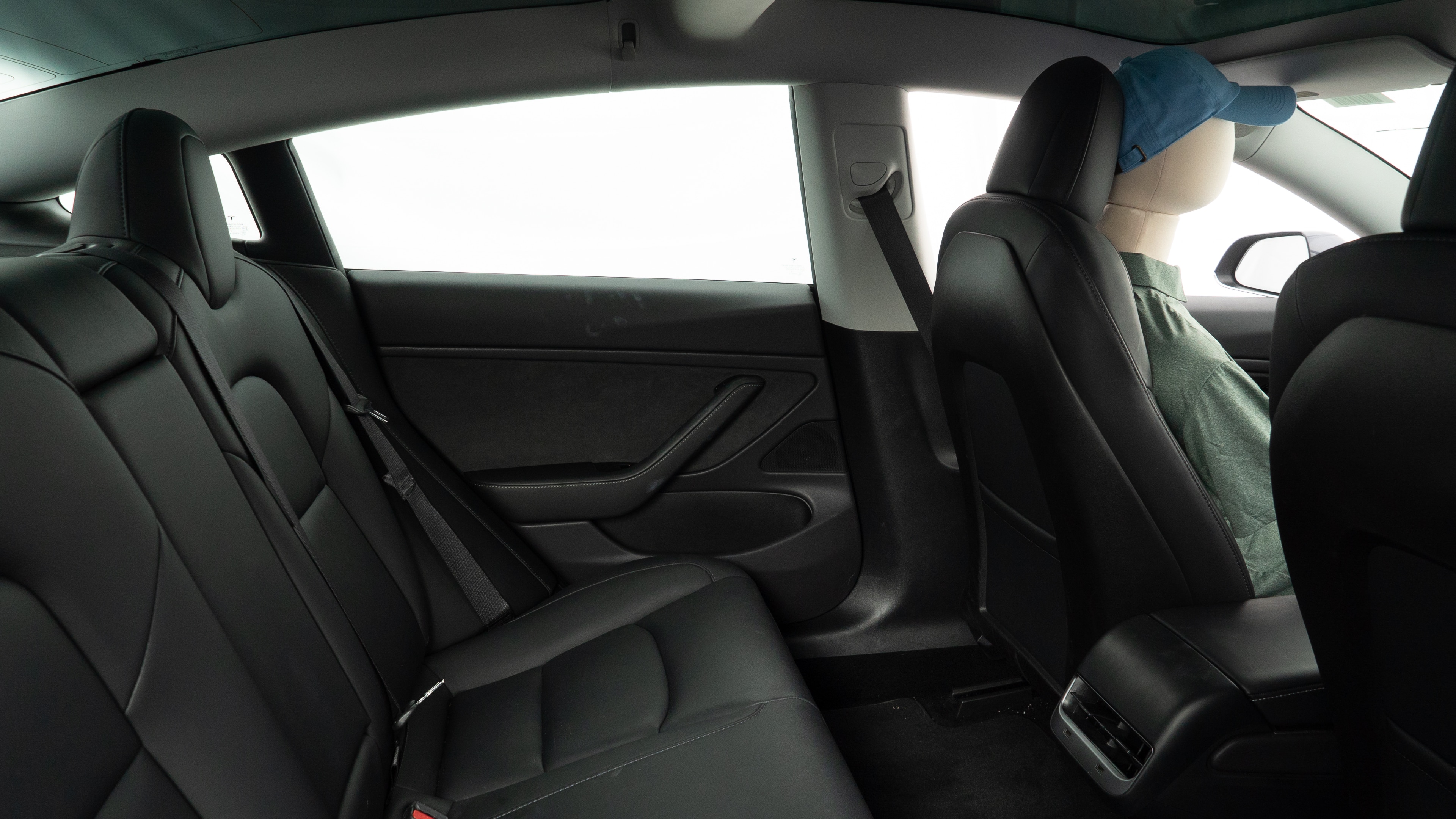 A series of second-row backseat photos is shown including one seating a baby seat and one seating a 6'1" mannequin.