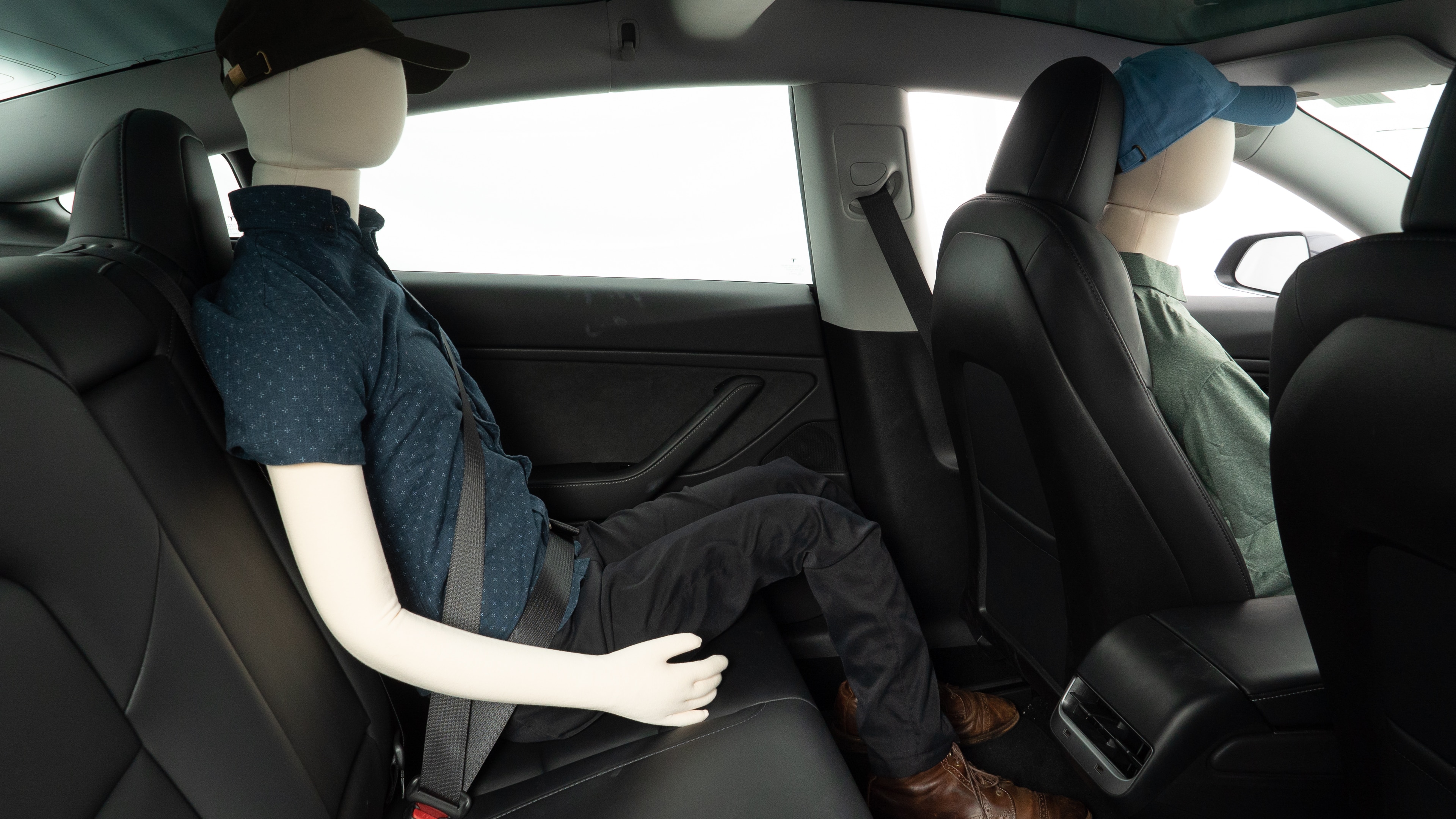 A series of second-row backseat photos is shown including one seating a baby seat and one seating a 6'1" mannequin.