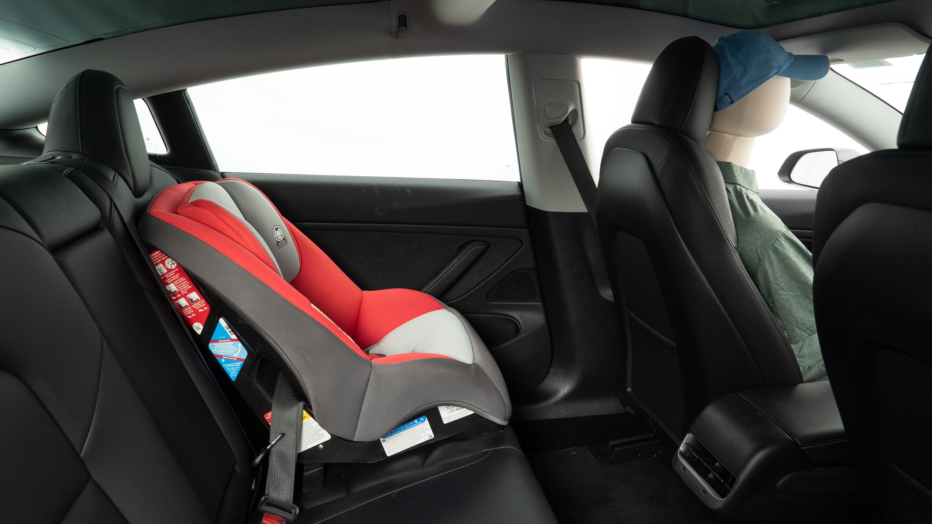 A series of second-row backseat photos is shown including one seating a baby seat and one seating a 6'1" mannequin.
