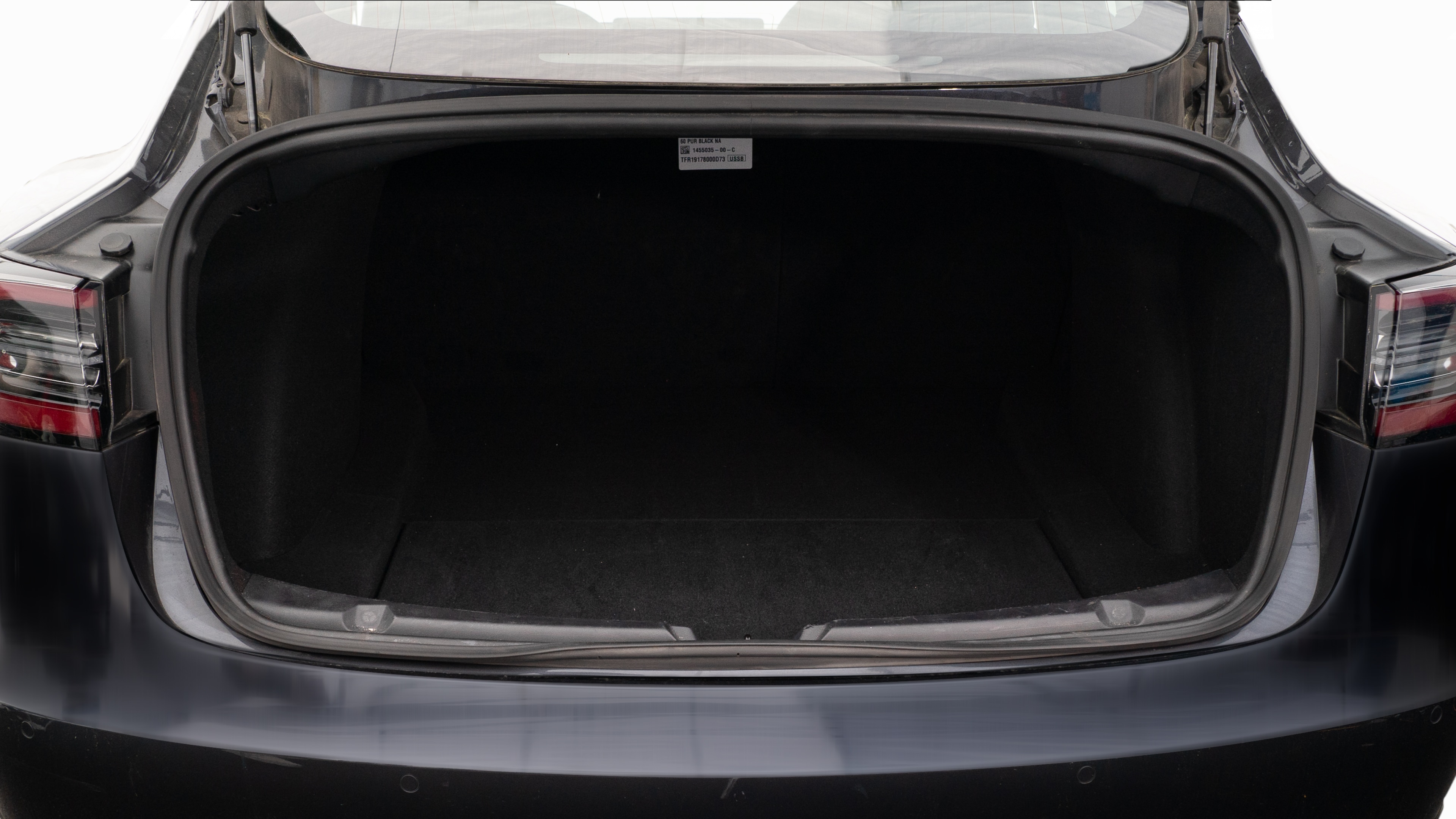 The trunk lid is open showing full view of the trunk. A baby stroller, two camping chairs in the carrying bag, and a set of golf clubs are placed inside.