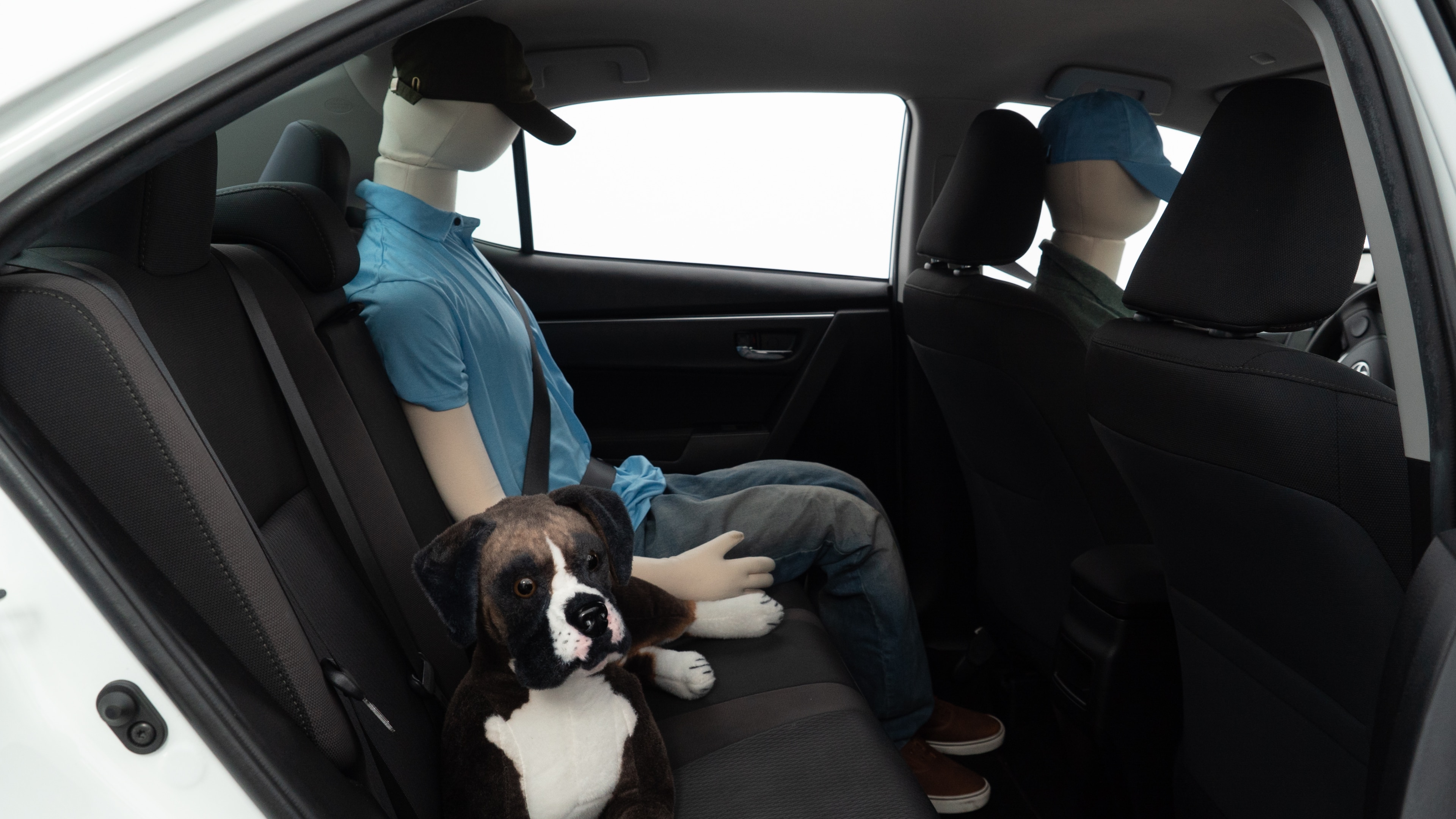 A series of second-row backseat photos is shown including one seating a baby seat and one seating a 6'1" mannequin