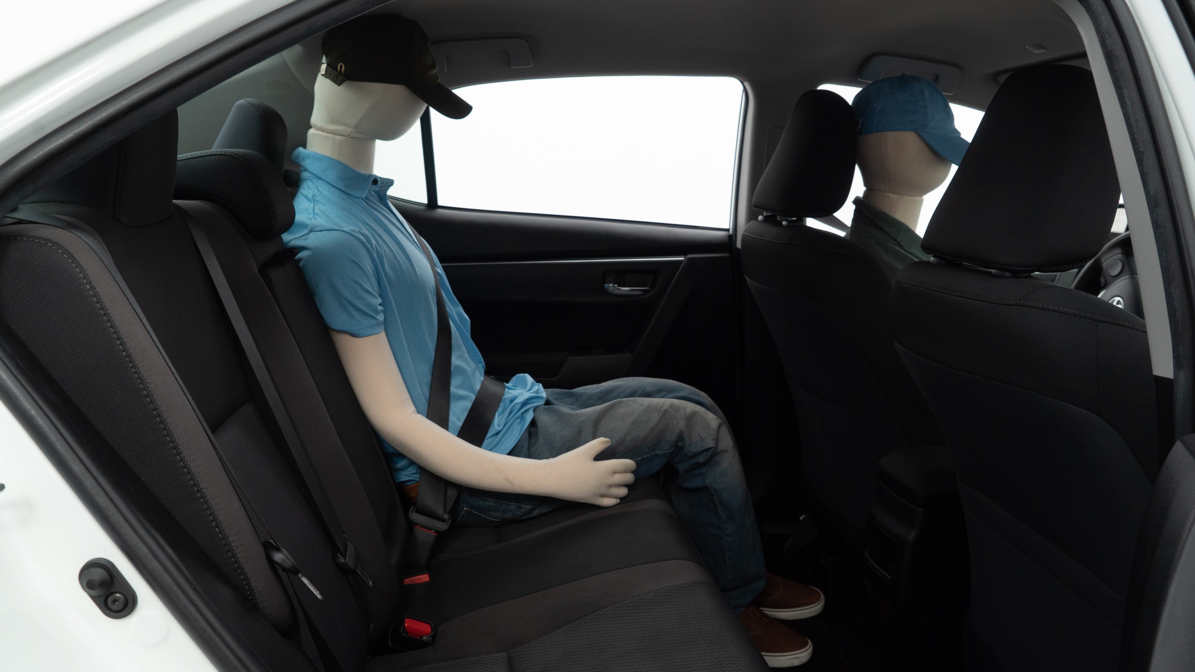 A series of second-row backseat photos is shown including one seating a baby seat and one seating a 6'1" mannequin