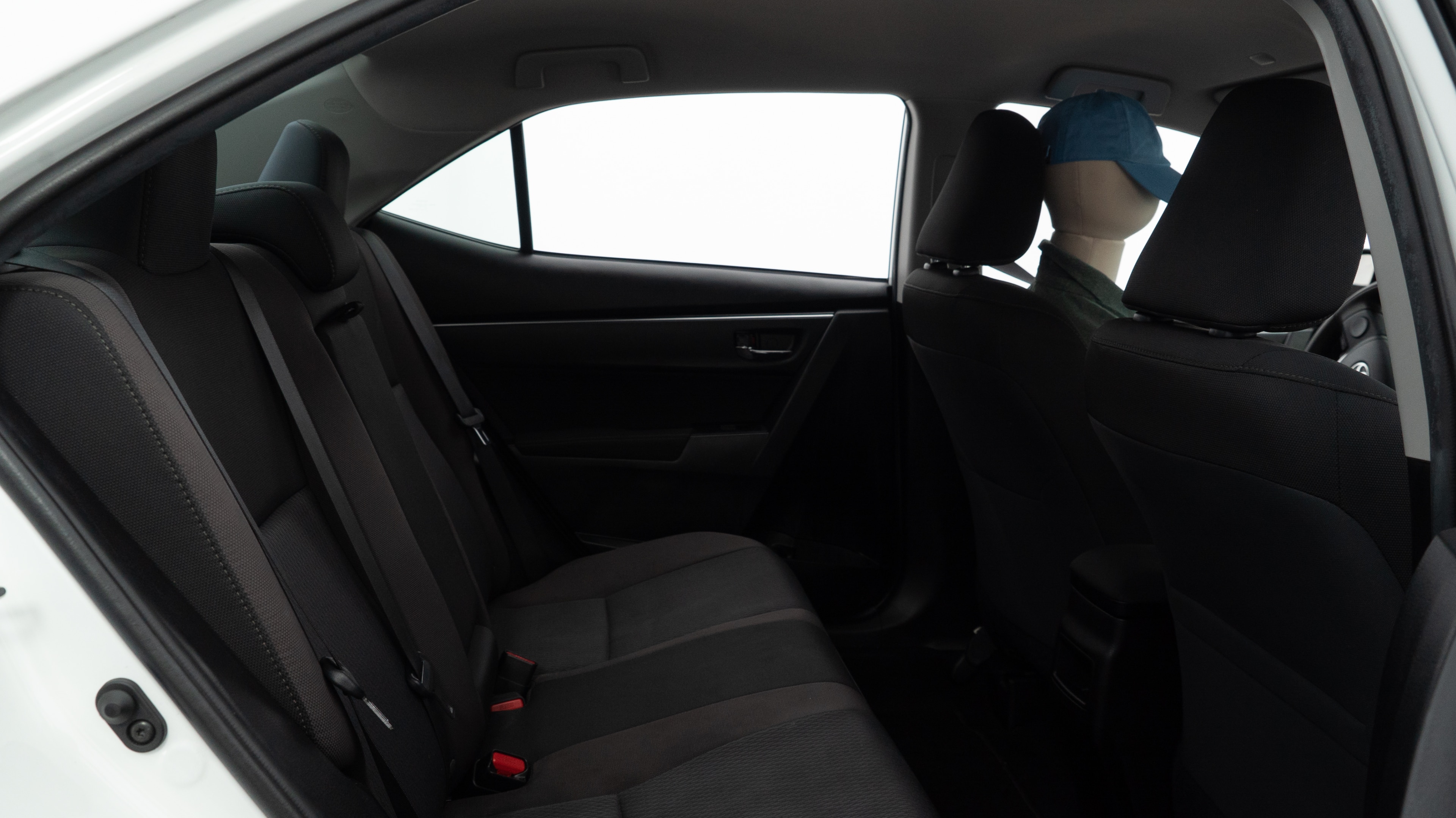 A series of second-row backseat photos is shown including one seating a baby seat and one seating a 6'1" mannequin