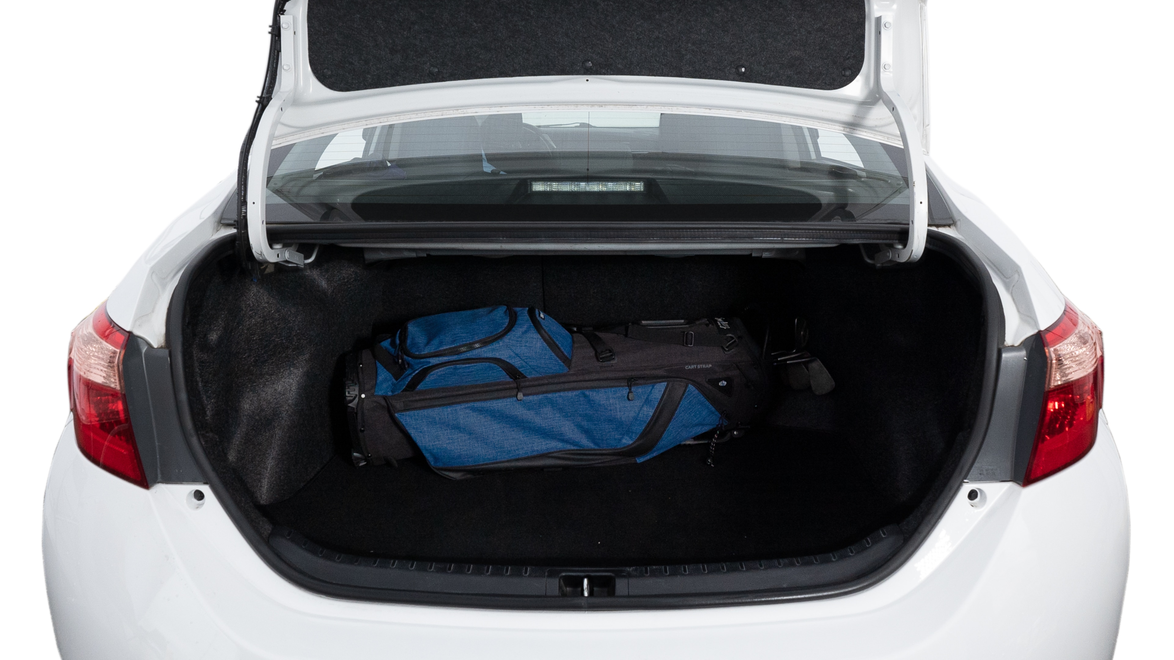 The trunk lid is open showing full view of the trunk. A baby stroller, three grocery carriers, two camping chairs in the carrying bag, and a set of golf clubs are placed inside.